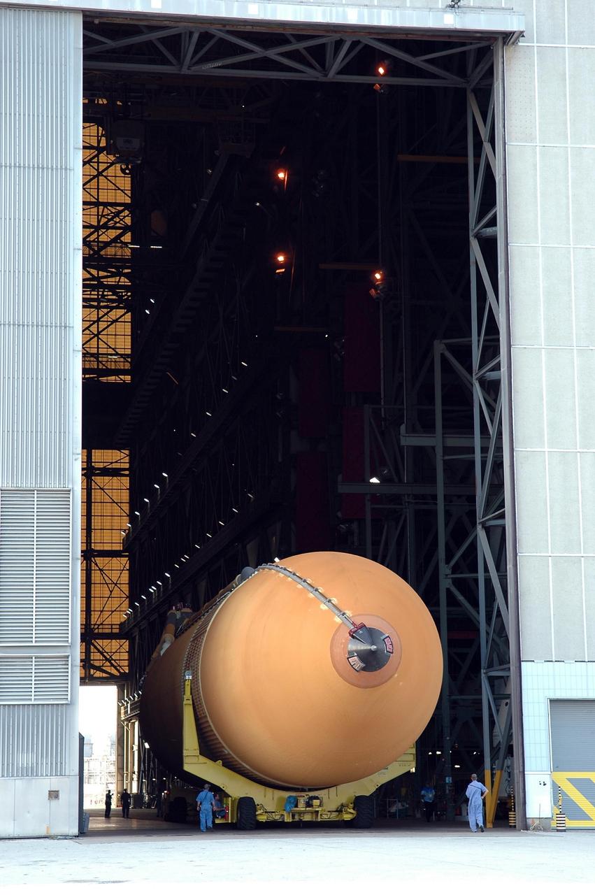 KENNEDY SPACE CENTER, FLA. - The redesigned external fuel tank, designated ET-118, rolls into the transfer aisle of the Vehicle Assembly Building where will be lifted into a checkout cell for further work . The tank arrived at KSC aboard the Pegasus barge after a journey from the Michoud Assembly Facility in New Orleans. ET-118, which will fly with many major safety changes, including the removal of the protuberance air load ramps, will launch Space Shuttle Atlantis on the next space shuttle mission, STS-115. Photo credit: NASA/Kim Shiflett
