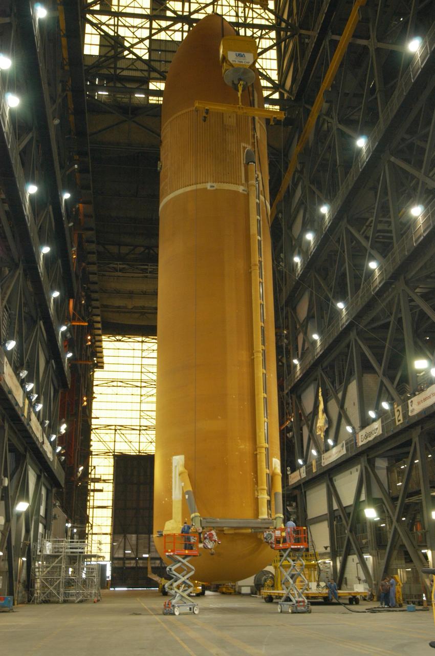 KENNEDY SPACE CENTER, FLA. - In the transfer aisle of NASA's Vehicle Assembly Building, the redesigned external fuel tank that will launch Space Shuttle Atlantis on the next shuttle mission, STS-115, is ready to be lifted into the upper levels for transfer into a checkout cell for further work. Designated ET-118, the tank will fly with many major safety changes, including the removal of the protuberance air load ramps. Photo credit: NASA/George Shelton