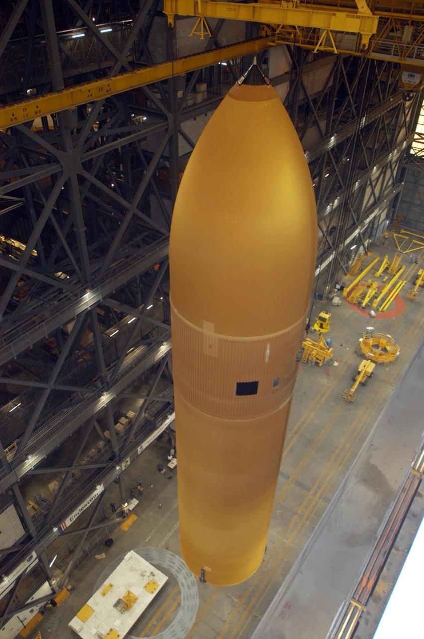 KENNEDY SPACE CENTER, FLA. - Seen from an upper level of NASA's Vehicle Assembly Building, the redesigned external fuel tank that will launch Space Shuttle Atlantis on the next shuttle mission, STS-115, is lifted for transfer into a checkout cell for further work. Designated ET-118, the tank will fly with many major safety changes, including the removal of the protuberance air load ramps. Photo credit: NASA/George Shelton