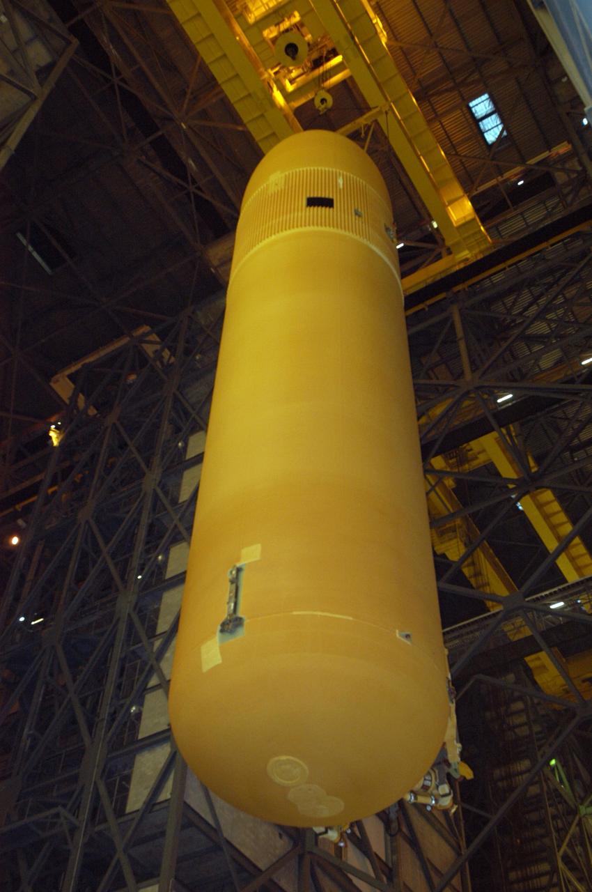 KENNEDY SPACE CENTER, FLA. - In NASA's Vehicle Assembly Building, the redesigned external fuel tank that will launch Space Shuttle Atlantis on the next shuttle mission, STS-115, is lifted toward the upper levels for transfer into a checkout cell for further work. Designated ET-118, the tank will fly with many major safety changes, including the removal of the protuberance air load ramps. Photo credit: NASA/George Shelton