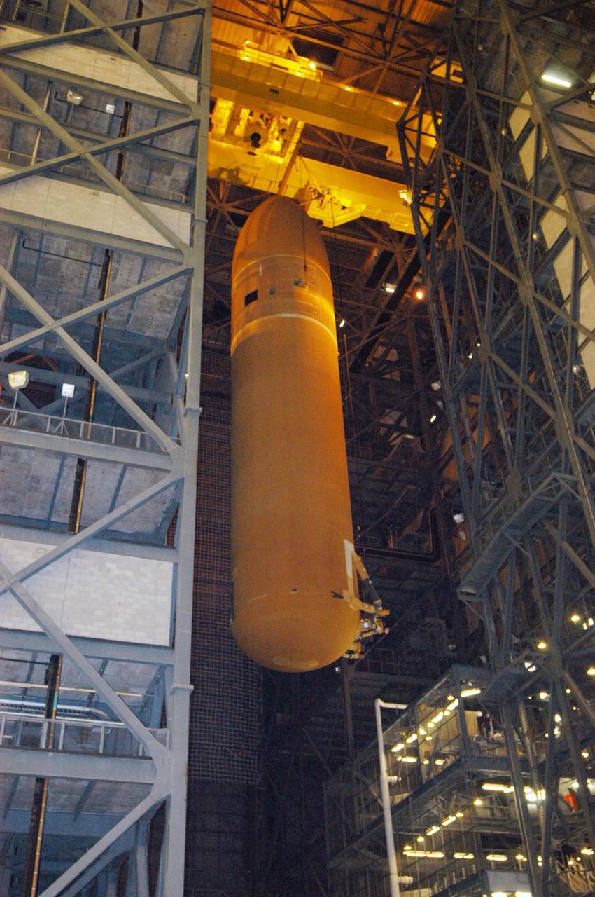 KENNEDY SPACE CENTER, FLA. - In NASA's Vehicle Assembly Building, the suspended external fuel tank that will launch Space Shuttle Atlantis on the next shuttle mission, STS-115, is moved toward the checkout cell where it will undergo further work. Designated ET-118, the tank will fly with many major safety changes, including the removal of the protuberance air load ramps. Photo credit: NASA/George Shelton