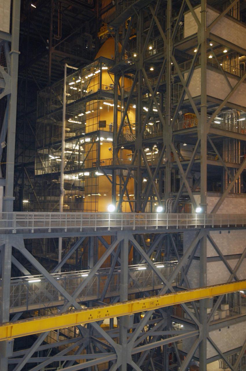 KENNEDY SPACE CENTER, FLA. - In NASA's Vehicle Assembly Building, the redesigned external fuel tank that will launch Space Shuttle Atlantis on the next shuttle mission, STS-115, is lowered into the checkout cell where it will undergo further work. Designated ET-118, the tank will fly with many major safety changes, including the removal of the protuberance air load ramps. Photo credit: NASA/George Shelton