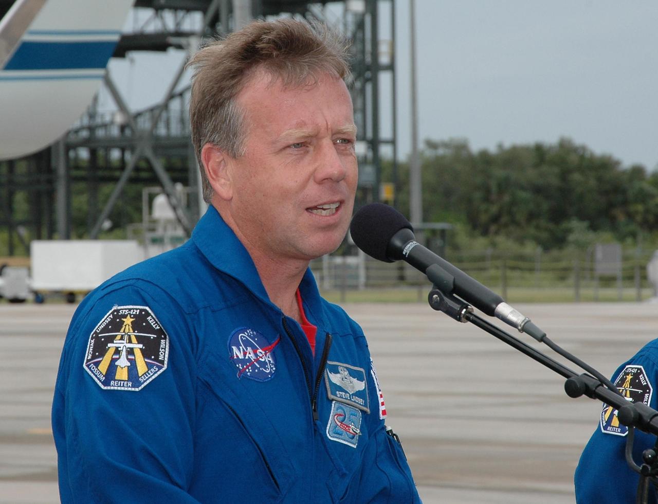 KENNEDY SPACE CENTER, FLA. - After landing at NASA's Kennedy Space Center aboard a Grumman G2 aircraft, Mission Commander Steven Lindsey pauses at a microphone to introduce the crew. Joining him are Mission Specialist Michael Fossum, Pilot Mark Kelly, and Mission Specialists Lisa Nowak (partly visible at left), Stephanie Wilson, Piers Sellers and Thomas Reiter, who represents the European Space Agency. The crew is at the space center to take part in a Terminal Countdown Demonstration Test, or TCDT. Over several days, the crew will practice emergency egress from the pad and suit up in their orange flight suits for the simulated countdown to launch. Space Shuttle Discovery is designated to launch July 1 on mission STS-121. It will carry supplies to the International Space Station. Photo credit: NASA/Kim Shiflett