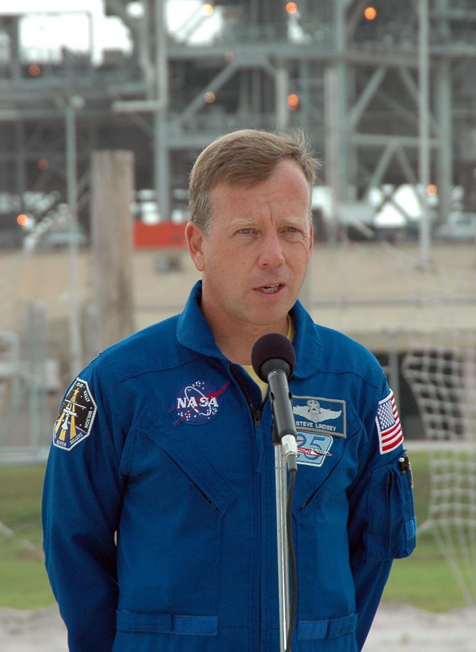 KENNEDY SPACE CENTER, FLA. - STS-121 Mission Commander Steven Lindsey talks to the media from the launch pad.  He is in the landing area of the slidewire baskets.  The crew is at Kennedy for Terminal Countdown Demonstration Test activities. Over several days, the crew will practice emergency egress from the pad and suit up in their orange flight suits for the simulated countdown to launch. Space Shuttle Discovery is designated to launch July 1 on mission STS-121.  It will carry supplies to the International Space Station.  Photo credit: NASA/Kim Shiflett
