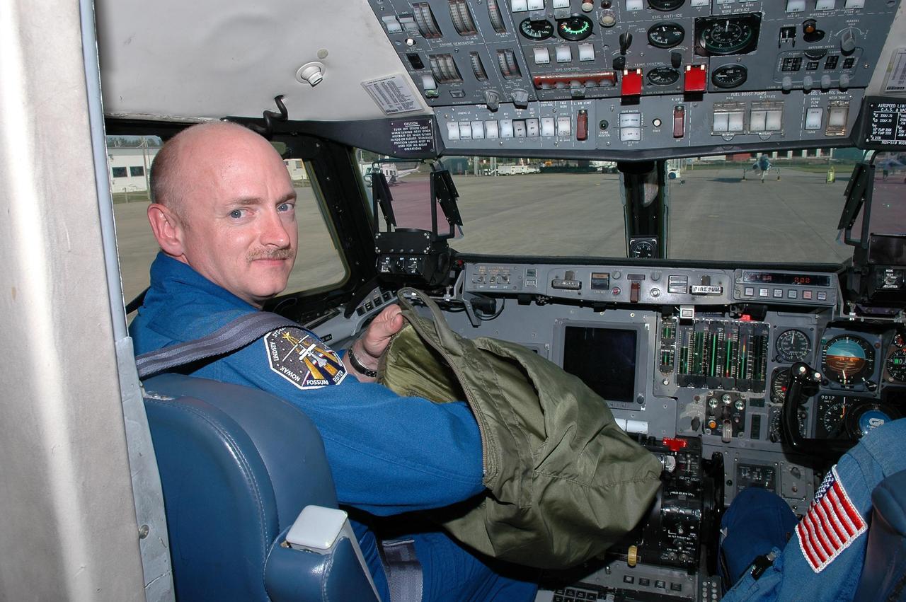 KENNEDY SPACE CENTER, FLA. - At the Shuttle Landing Facility, STS-121 Pilot Mark Kelly gets ready for a training flight in a Shuttle Training Aircraft (STA).  He will be practicing landing the orbiter using the STA, which is a modified Grumman American Aviation-built Gulf Stream II jet that was modified to simulate an orbiter’s cockpit, motion and visual cues, and handling qualities. In flight, the STA duplicates the orbiter’s atmospheric descent trajectory from approximately 35,000 feet altitude to landing on a runway. Because the orbiter is unpowered during re-entry and landing, its high-speed glide must be perfectly executed the first time. Space Shuttle Discovery is scheduled to launch July 1 on mission STS-121.  Photo credit: NASA/Kim Shiflett