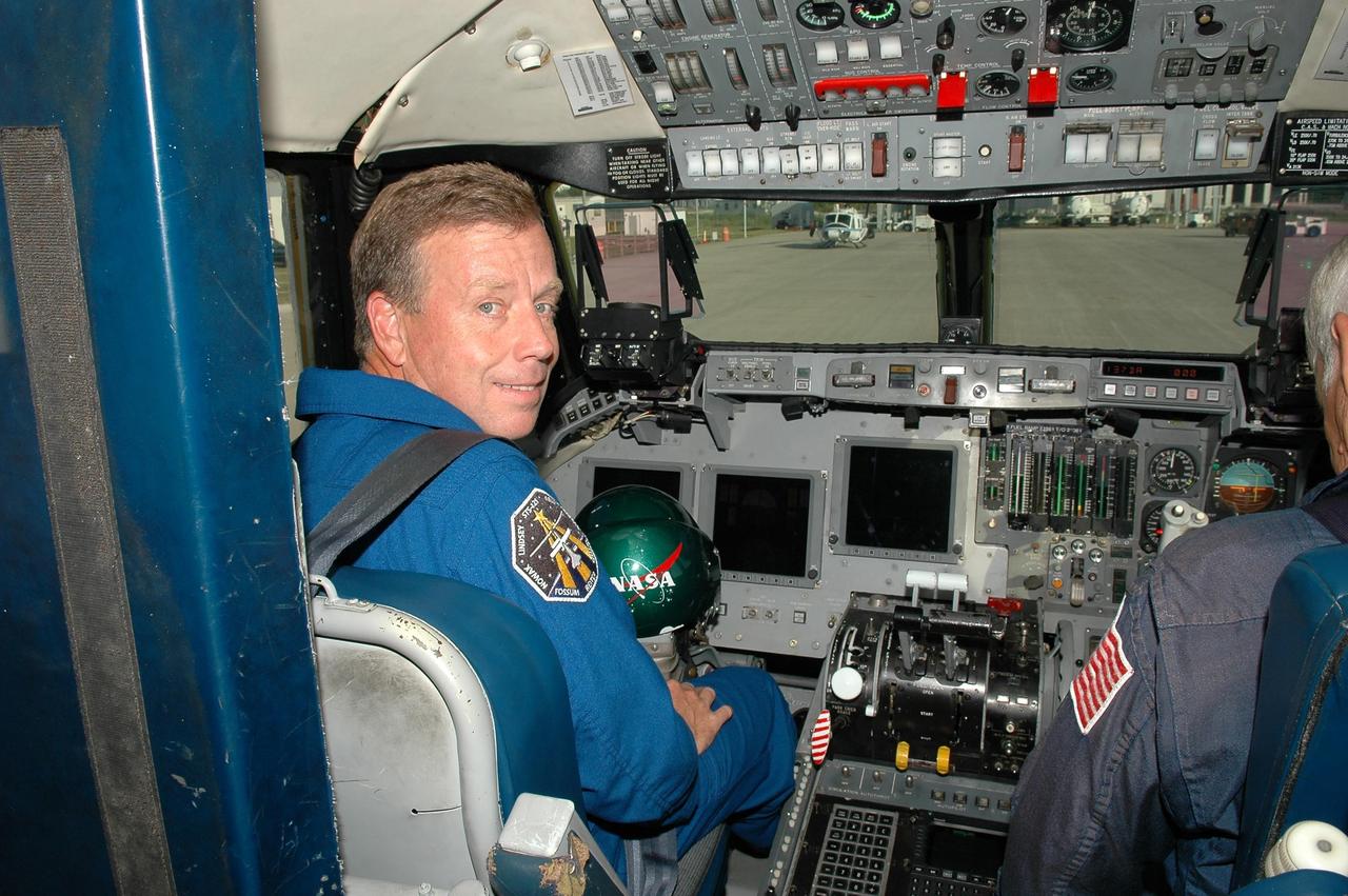 KENNEDY SPACE CENTER, FLA. - At the Shuttle Landing Facility, STS-121 Commander Steven Lindsey gets ready for a training flight in a Shuttle Training Aircraft (STA). He will be practicing landing the orbiter using the STA, which is a modified Grumman American Aviation-built Gulf Stream II jet that was modified to simulate an orbiter’s cockpit, motion and visual cues, and handling qualities. In flight, the STA duplicates the orbiter’s atmospheric descent trajectory from approximately 35,000 feet altitude to landing on a runway. Because the orbiter is unpowered during re-entry and landing, its high-speed glide must be perfectly executed the first time. Space Shuttle Discovery is scheduled to launch July 1 on mission STS-121. Photo credit: NASA/Kim Shiflett