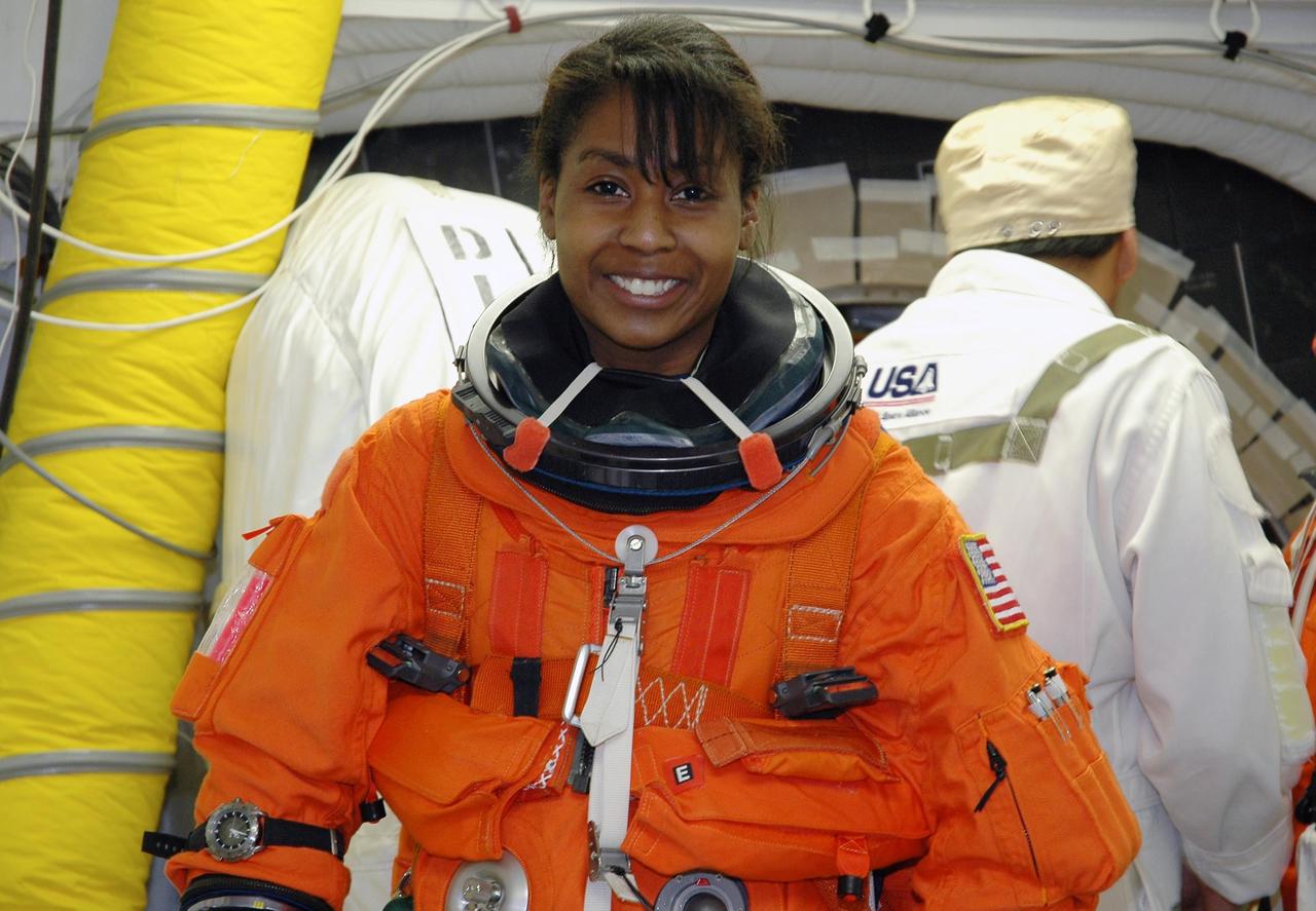 KENNEDY SPACE CENTER, FLA. - In the White Room on Launch Pad 39B, STS-121 Mission Specialist Stephanie Wilson waits for final adjustments to her launch suit before entering Space Shuttle Discovery. The crew is taking part in a full dress rehearsal for launch, including countdown and culminating in main engine cutoff. The rehearsal is the final part of Terminal Countdown Demonstration Test (TCDT) activities that the crew has been involved in for two days. TCDT provides the crew of each mission an opportunity to participate in various simulated countdown activities, including equipment familiarization and emergency egress training. Mission STS-121 is scheduled to be launched July 1. Photo credit: NASA/Amanda Diller