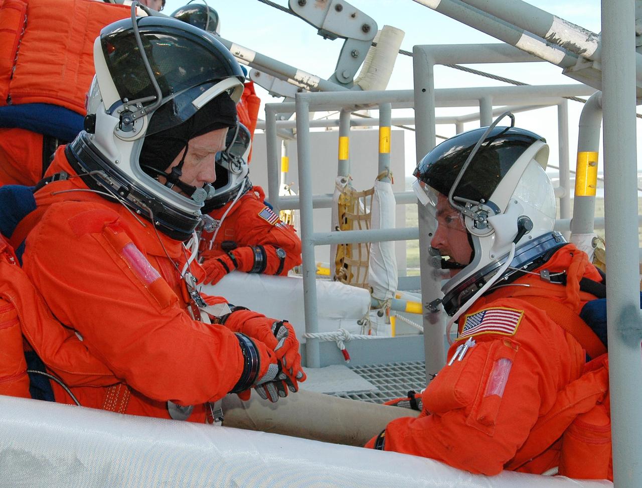 KENNEDY SPACE CENTER, FLA. - STS-121 Commander Steven Lindsey (left) and Pilot Mark Kelly take part in emergency egress practice, part of the Terminal Countdown Demonstration Test (TCDT) activities that include a simulated countdown culminating in main engine cutoff. Mission STS-121 is scheduled to be launched July 1. Photo credit: NASA/Kim Shiflett