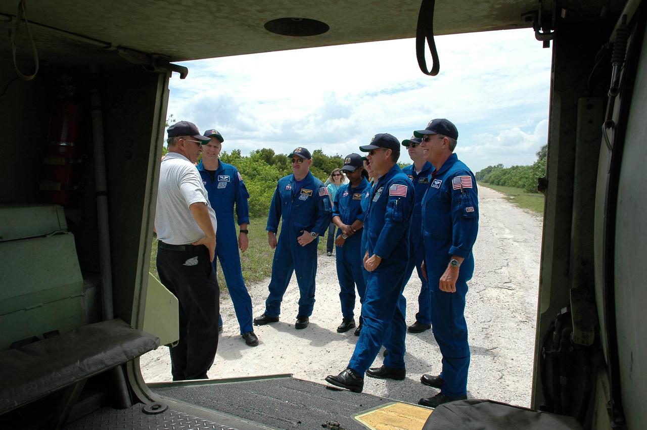 KENNEDY SPACE CENTER, FLA. -   During Terminal Countdown Demonstration Test (TCDT) activities, the STS-121 crew gets instructions about emergency egress from the pad from Capt. George Hoggard (left), who is astronaut rescue team leader.  Crew members are (from left) Mission Specialist Piers Sellers, Pilot Mark Kelly, Mission Specialists Stephanie Wilson and Lisa Nowak, Commander Steven Lindsey, and Mission Specialists Thomas Reiter and Michael Fossum. Part of the training will be driving an M-113, which is an armored personnel carrier. Mission STS-121 is designated for launch on July 1.   Photo credit: NASA/Kim Shiflett
