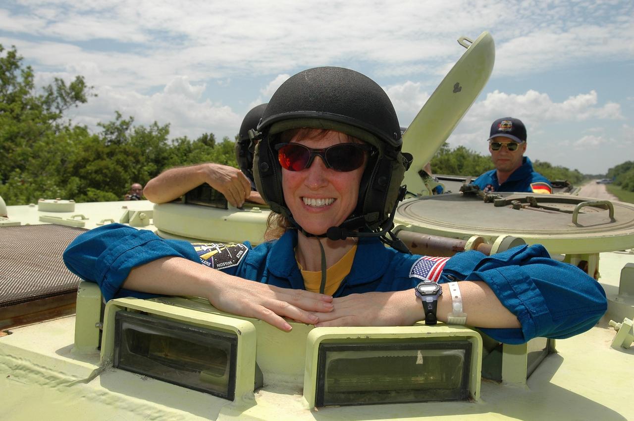 KENNEDY SPACE CENTER, FLA. -   STS-121 Mission Specialist Lisa Nowak takes her turn in an M-113, which is an armored personnel carrier.  Behind her, at right, is Mission Specialist Thomas Reiter from Germany, and represents the European Space Agency.  The STS-121 crew is taking turns driving the M-113 as part of Terminal Countdown Demonstration Test activities, which include emergency egress training from the pad and a simulated countdown.  Mission STS-121 is designated for launch on July 1.   Photo credit: NASA/Kim Shiflett