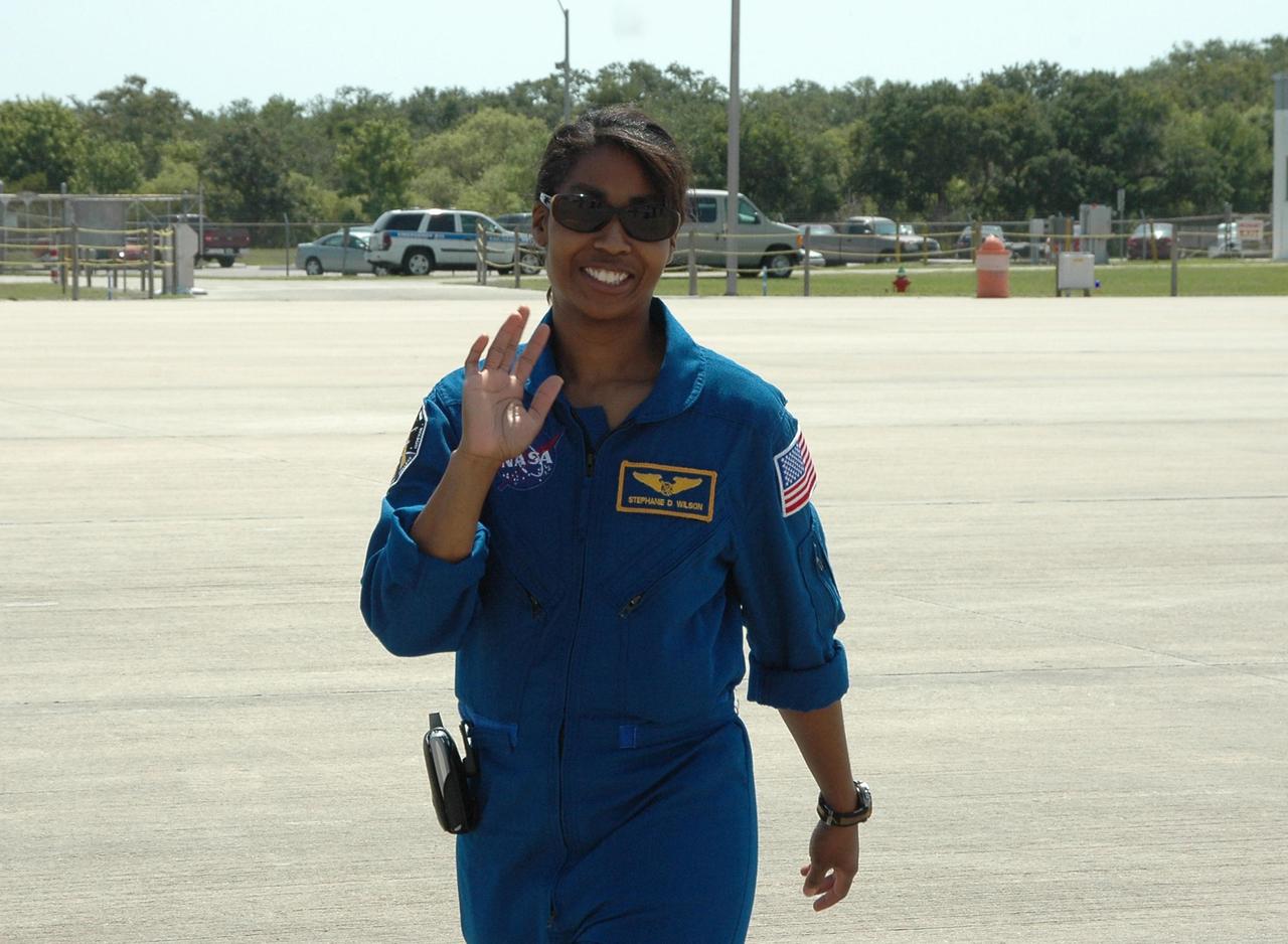 KENNEDY SPACE CENTER, FLA. - After a three-day series of Terminal Countdown Demonstration Test (TCDT) activities, the crew of mission STS-121 are leaving NASA's Kennedy Space Center to return to Houston. Waving on her way to the plane at the Shuttle Landing Facility is Mission Specialist Stephanie Wilson. The TCDT includes equipment familiarization, emergency egress training and a simulated launch countdown. Mission STS-121 is scheduled to launch July 1. Photo credit: NASA/Kim Shiflett