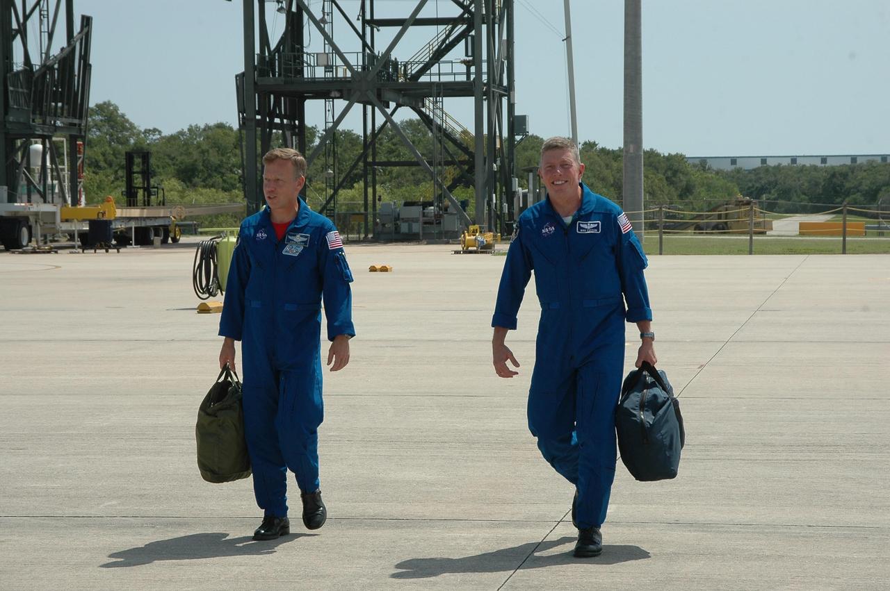 KENNEDY SPACE CENTER, FLA. - After a three-day series of Terminal Countdown Demonstration Test (TCDT) activities, the crew of mission STS-121 are leaving NASA's Kennedy Space Center to return to Houston. Walking to the plane at the Shuttle Landing Facility are Commander Steven Lindsey (left) and Mission Specialist Michael Fossum. The TCDT includes equipment familiarization, emergency egress training and a simulated launch countdown. Mission STS-121 is scheduled to launch July 1. Photo credit: NASA/Kim Shiflett