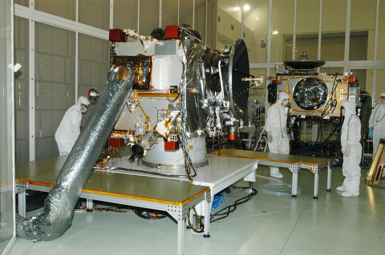 KENNEDY SPACE CENTER, FLA. - At Astrotech Space Operations in Titusville, Fla., the two STEREO spacecraft are being prepared for installation of the solar arrays. In the foreground is spacecraft "B," sitting as it would on the rocket. Pointing to the right is the high gain antenna (HGA), which is used to get science data at high data rates back to Earth. In the background is the "A" observatory, rotated horizontally on a Ransome table so that its HGA is pointing upward. The black circle facing forward is the primary instrument Sun Earth Connection Coronal and Heliospheric Investigation (SECCHI), a suite of remote sensing instruments to image solar flares, with a protective cover that is removed before flight. STEREO consists of two spacecraft whose mission is the first to take measurements of the sun and solar wind in 3-D. This new view will improve our understanding of space weather and its impact on the Earth. Preparations are under way for a liftoff aboard a Delta rocket no earlier than July 22. Photo credit: NASA/George Shelton
