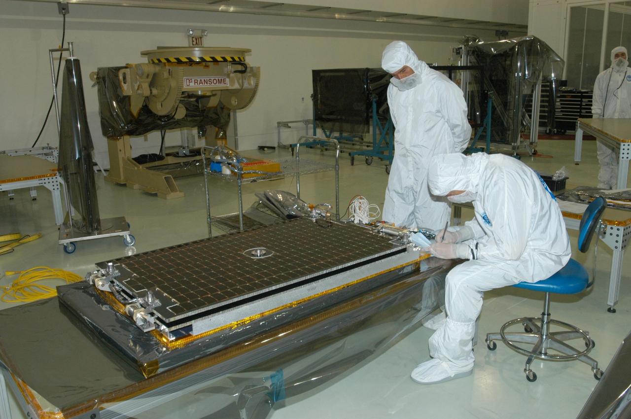 KENNEDY SPACE CENTER, FLA. -   At Astrotech Space Operations in Titusville, Fla., engineers get ready to install the solar array in front of them on the STEREO spacecraft.  STEREO consists of two spacecraft whose mission is the first to take measurements of the sun and solar wind in 3-D. This new view will improve our understanding of space weather and its impact on the Earth.  Preparations are under way for a liftoff aboard a Delta rocket no earlier than July 22. Photo credit: NASA/George Shelton