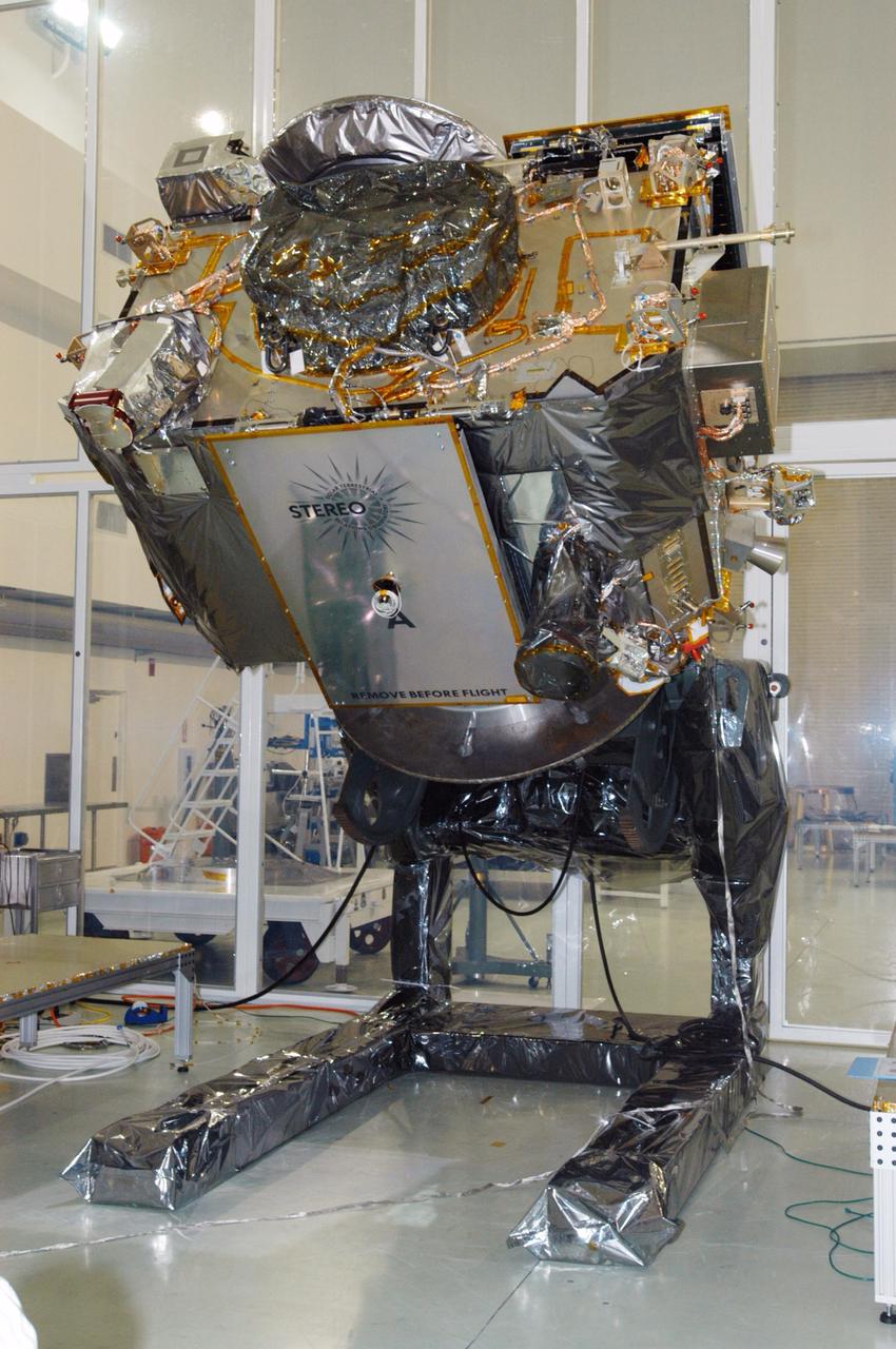 KENNEDY SPACE CENTER, FLA. - At Astrotech Space Operations in Titusville, Fla., the tilt table lowers the STEREO spacecraft "A." In this position, technicians can perform the final comprehensive performance test of the instruments, verifying the instrument is fully functional before flight. After a rotation, this configuration also allows deployment tests to be done on the solar arrays. STEREO stands for Solar Terrestrial Relations Observatory. The STEREO mission is the first to take measurements of the sun and solar wind in 3-dimension. This new view will improve our understanding of space weather and its impact on the Earth. STEREO is expected to lift off aboard a Boeing Delta II rocket on July 22. Photo credit: NASA/George Shelton