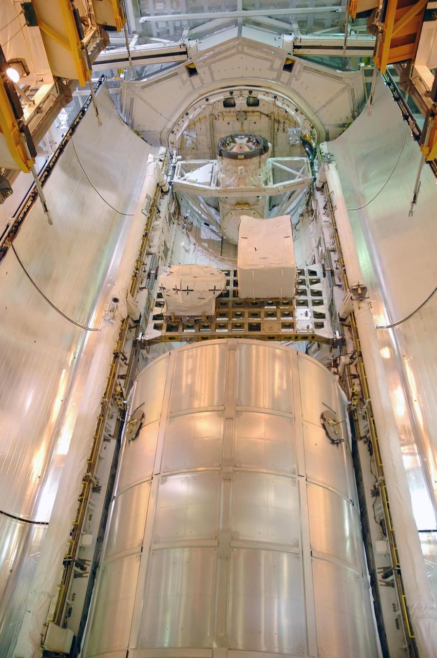 KENNEDY SPACE CENTER, FLA. -    At Launch Pad 39B, the open doors of Space Shuttle Discovery's payload bay show the cargo the orbiter will carry into orbit.  At the lower end is multi-purpose logistics module Leonardo.  Above it is the integrated cargo carrier that holds the mobile transporter reel assembly the astronauts will replace on the station and a spare pump module.   Discovery is scheduled to launch at 3:48 p.m. July 1 carrying a crew of seven on the 12-day mission to the International Space Station.  Photo credit: NASA/Charisse Nahser
