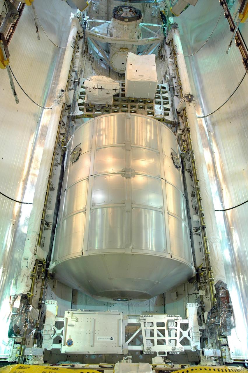 KENNEDY SPACE CENTER, FLA. -   At Launch Pad 39B, the payload bay doors on Space Shuttle Discovery are being closed for launch.  Seen inside is the multi-purpose logistics module Leonardo, at bottom, and the integrated cargo carrier above it.  Discovery is scheduled to launch on mission STS-121 at 3:49 p.m. July 1 carrying a crew of seven on the 12-day mission to the International Space Station. Photo credit: NASA/Jim Grossmann
