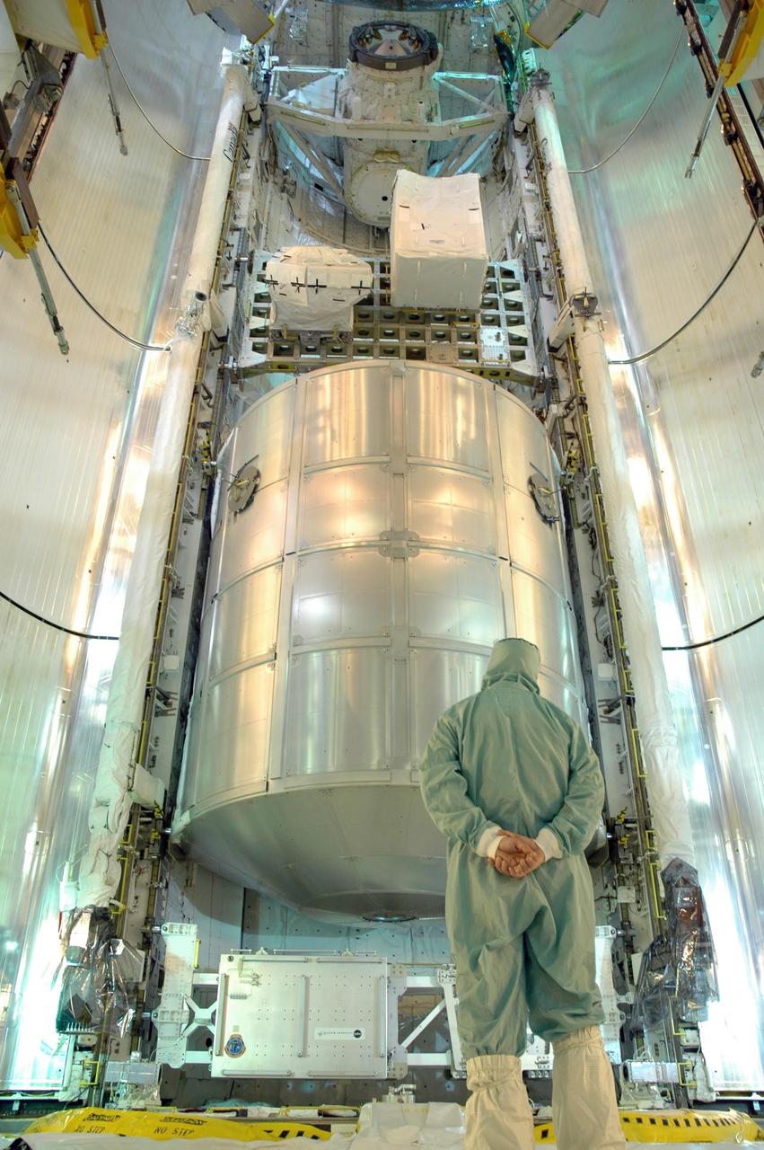 KENNEDY SPACE CENTER, FLA. -   At Launch Pad 39B, a technician stands by for the closing of Space Shuttle Discovery's payload bay doors for launch.  Seen inside is the multi-purpose logistics module Leonardo, at bottom, and the integrated cargo carrier above it.  Discovery is scheduled to launch on mission STS-121 at 3:49 p.m. July 1 carrying a crew of seven on the 12-day mission to the International Space Station. Photo credit: NASA/Jim Grossmann