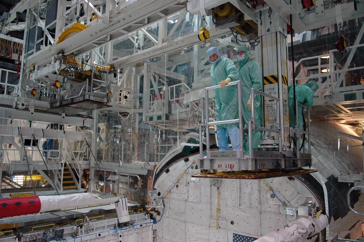 KENNEDY SPACE CENTER, FLA. -   In the Orbiter Processing Facility at NASA's Kennedy Space Center, STS-115 crew members inspect equipment in Atlantis's payload bay.  The crew is at KSC for Crew Equipment Interface Test activities, which involves equipment familiarization,  a routine part of astronaut training and launch preparations.  The STS-115 mission will deliver the second port truss segment, the P3/P4 truss, to the International Space Station.  The crew will attach the P3 to the first port truss segment, the P1 truss, as well as deploy solar array set 2A and 4A.  Launch on Space Shuttle Atlantis is scheduled for late August. Photo credit: NASA/Kim Shiflett