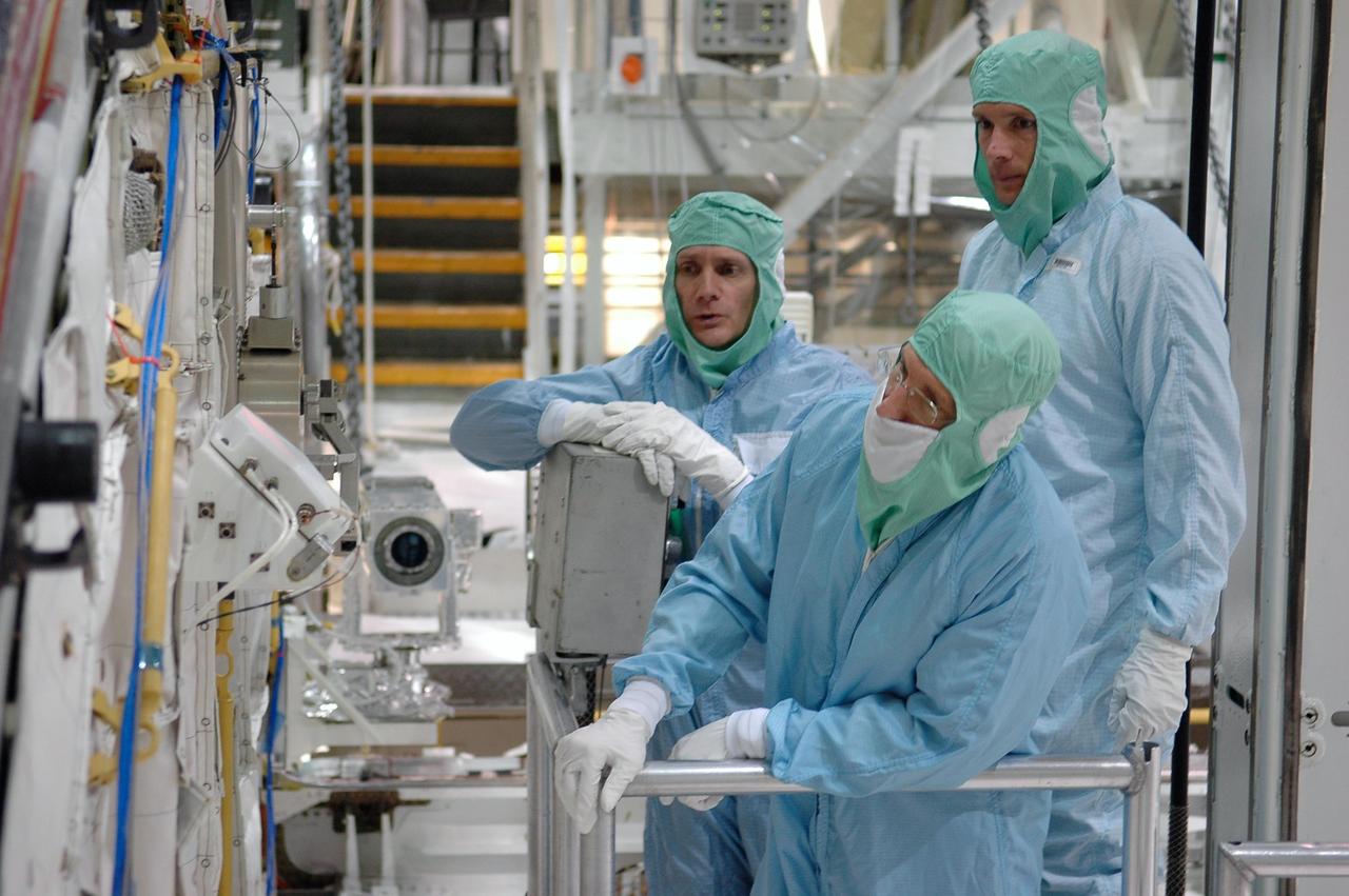 KENNEDY SPACE CENTER, FLA. -  In the Orbiter Processing Facility at NASA's Kennedy Space Center, STS-115 crew members inspect equipment in Atlantis's payload bay.  Looking at the airlock are Mission Specialists Steven MacLean (left) and Daniel Burbank (foreground). The crew is at KSC for Crew Equipment Interface Test activities, which involves equipment familiarization,  a routine part of astronaut training and launch preparations.  The STS-115 mission will deliver the second port truss segment, the P3/P4 truss, to the International Space Station.  The crew will attach the P3 to the first port truss segment, the P1 truss, as well as deploy solar array set 2A and 4A.  Launch on Space Shuttle Atlantis is scheduled for late August. Photo credit: NASA/Kim Shiflett