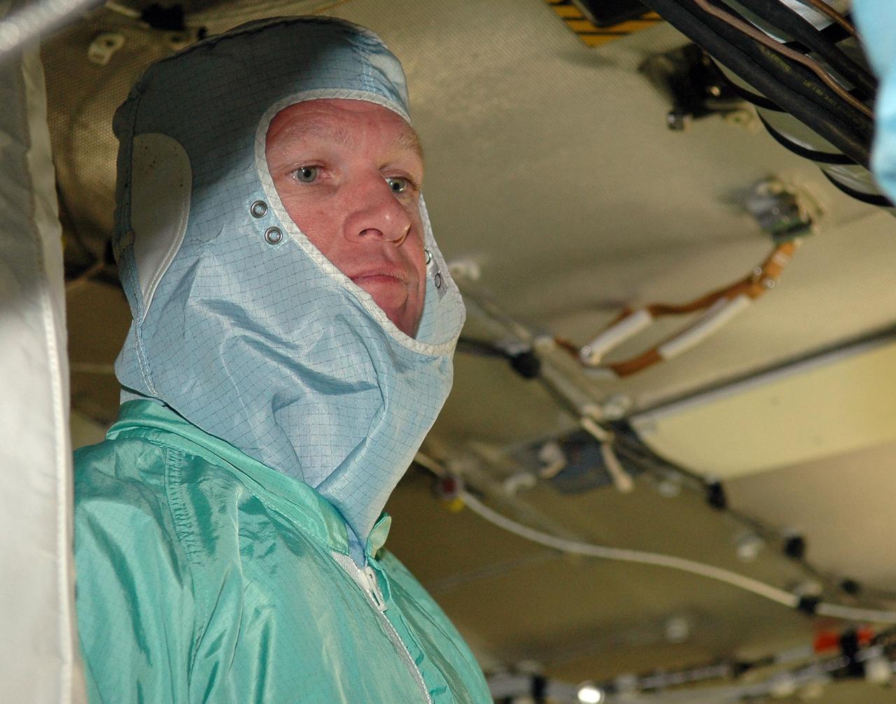 KENNEDY SPACE CENTER, FLA. -  In the Orbiter Processing Facility, STS-115 Commander Brent Jett completes inspection of the orbiter Atlantis.   The crew is at KSC for Crew Equipment Interface Test activities, which involve equipment familiarization and inspection, a routine part of astronaut training and launch preparations.  The STS-115 mission will deliver the second port truss segment, the P3/P4 truss, to the International Space Station.  The crew will attach the P3 to the first port truss segment, the P1 truss, as well as deploy solar array set 2A and 4A.  Launch on Space Shuttle Atlantis is scheduled for late August. Photo credit: NASA/Kim Shiflett
