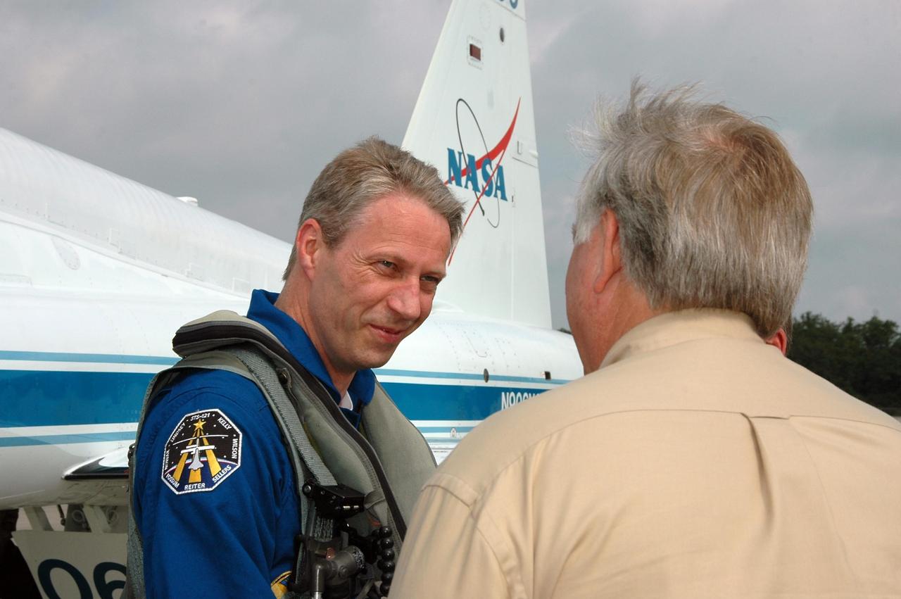 KENNEDY SPACE CENTER, FLA. -   STS-121 Mission Specialist Thomas Reiter is greeted by Center Director Jim Kennedy after arriving at KSC to get ready for launch on July 1. The launch will be his first space flight.  During the 12-day mission, the STS-121 crew will test new equipment and procedures to improve shuttle safety, as well as deliver supplies and make repairs to the International Space Station. This mission is the 115th shuttle flight and the 18th U.S. flight to the International Space Station.  Photo credit: NASA/Kim Shiflett