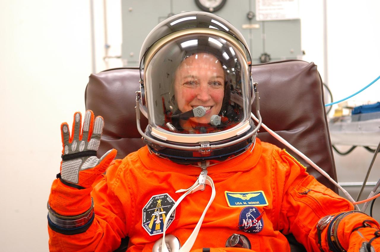 KENNEDY SPACE CENTER, FLA. - Excited about her first space flight, STS-121 Mission Specialist Lisa Nowak completes a fitting on her launch suit in the Operations and Checkout Building. The crew is making final preparations for the launch on July 1 to the International Space Station. On the 12-day mission, the crew will test new equipment and procedures to improve shuttle safety, as well as deliver supplies and make repairs to the station. This mission is the 115th shuttle flight and the 18th U.S. flight to the station. Photo credit: NASA/Kim Shiflett