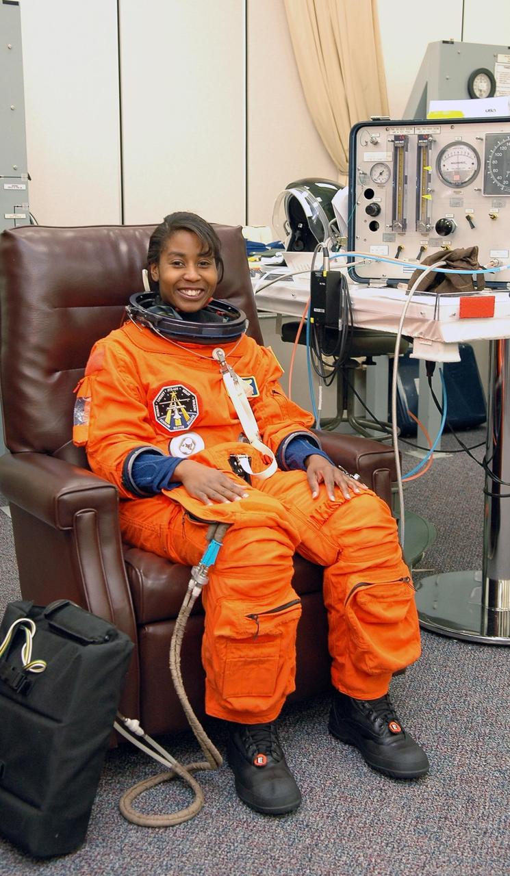 KENNEDY SPACE CENTER, FLA. - Excited about her first space flight, STS-121 Mission Specialist Stephanie Wilson has her launch suit checked for fit in the Operations and Checkout Building. On the 12-day mission, the crew will test new equipment and procedures to improve shuttle safety, as well as deliver supplies and make repairs to the station. This mission is the 115th shuttle flight and the 18th U.S. flight to the station. Photo credit: NASA/Kim Shiflett