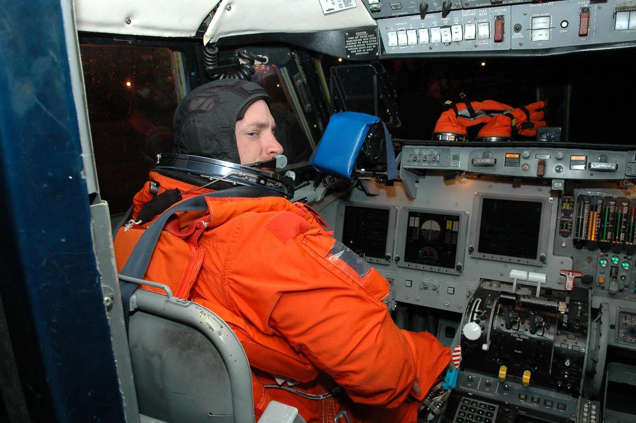KENNEDY SPACE CENTER, FLA. -  Inside the Shuttle Training Aircraft (STA), STS-121 Pilot Mark Kelly takes control in the cockpit.  Kelly and Commander Steven Lindsey will be making practice landings in preparation for the July 1 launch of Space Shuttle Discovery.  The STA is a Grumman American Aviation-built Gulf Stream II jet that was modified to simulate an orbiter’s cockpit, motion and visual cues, and handling qualities. In flight, the STA duplicates the orbiter’s atmospheric descent trajectory from approximately 35,000 feet altitude to landing on a runway. Because the orbiter is unpowered during re-entry and landing, its high-speed glide must be perfectly executed the first time.  Photo credit: NASA/Kim Shiflett