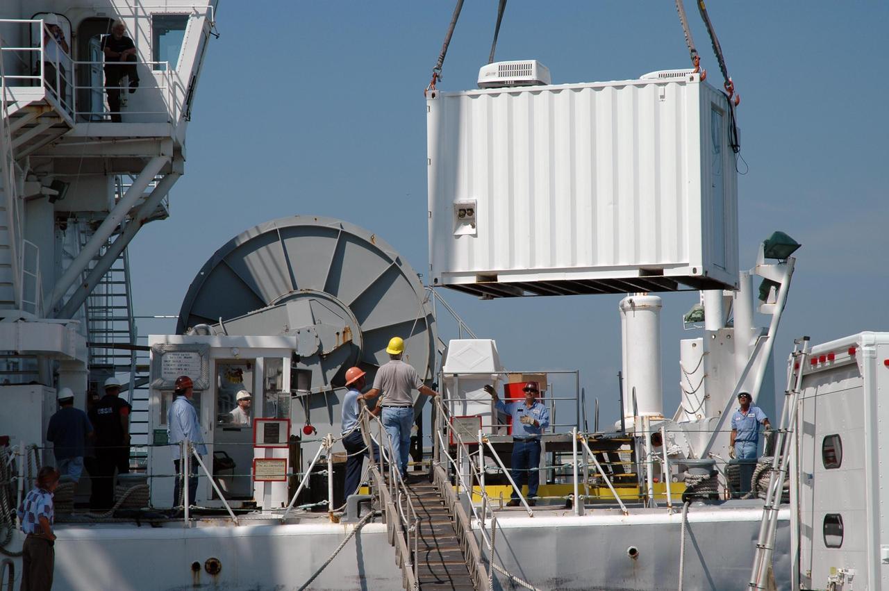 KENNEDY SPACE CENTER, FLA. -   A support equipment module for an X-band radar is being loaded on the U.S. Naval Ship Hayes at Port Canaveral in Florida to support the July 1 launch of Space Shuttle Discovery on mission STS-121. There are two Continuous Pulse Doppler X-band radars located on ships for the STS-121 launch.  The other one is mounted on a booster recovery ship downrange of the launch site. The two radars provide velocity and differential Shuttle/debris motion information.  Combined with the C-band radar located at the Haulover Canal near the launch site, they provide high definition images of any debris that might fall from the external tank/shuttle.  The X-band data (screen captures) will be sent from the ships via satellite link to the National Center for Atmospheric Research site.  Photo credit: NASA/Jim Grossmann