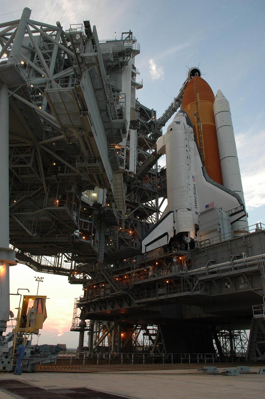 KENNEDY SPACE CENTER, FLA. -  In preparation for the July 1 launch of Space Shuttle Discovery on mission STS-121, the Launch Pad 39B rotating service structure (RSS) enclosing the shuttle rolls away.  The RSS provides protected access to the orbiter for changeout and servicing of payloads at the pad. The structure is supported by a rotating bridge that pivots about a vertical axis on the west side of the pad's flame trench. The hinge column rests on the pad surface and is braced to the fixed service structure. Support for the outer end of the bridge is provided by two eight-wheel, motor-driven trucks that move along circular twin rails installed flush with the pad surface. The track crosses the flame trench on a permanent bridge.  The RSS is 102 feet long, 50 feet wide and 130 feet high. The structure has orbiter access platforms at five levels to provide access to the payload bay while the orbiter is being serviced in the RSS. Each platform has independent extendable planks that can be arranged to conform to a payload's configuration.  This mission is the 115th shuttle flight and the 18th U.S. flight to the International Space Station. Photo credit: NASA/Kim Shiflett