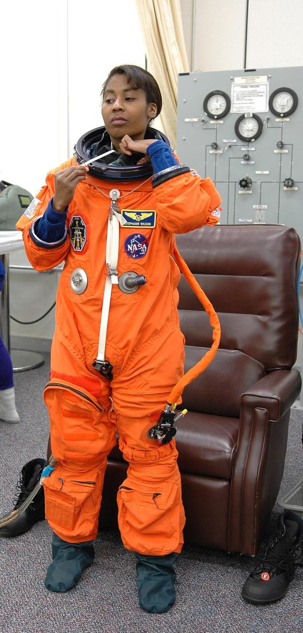 KENNEDY SPACE CENTER, FLA. -   The STS-121 crew are donning their orange launch and entry suits for launch today on Space Shuttle Discovery.  Standing here is Mission Specialist Stephanie Wilson, who is making her first space flight.  The launch is the 115th shuttle flight and the 18th U.S. flight to the International Space Station.  During the 12-day mission, the STS-121 crew will test new equipment and procedures to improve shuttle safety, as well as deliver supplies and make repairs to the International Space Station.  Photo credit: NASA/Kim Shiflett
