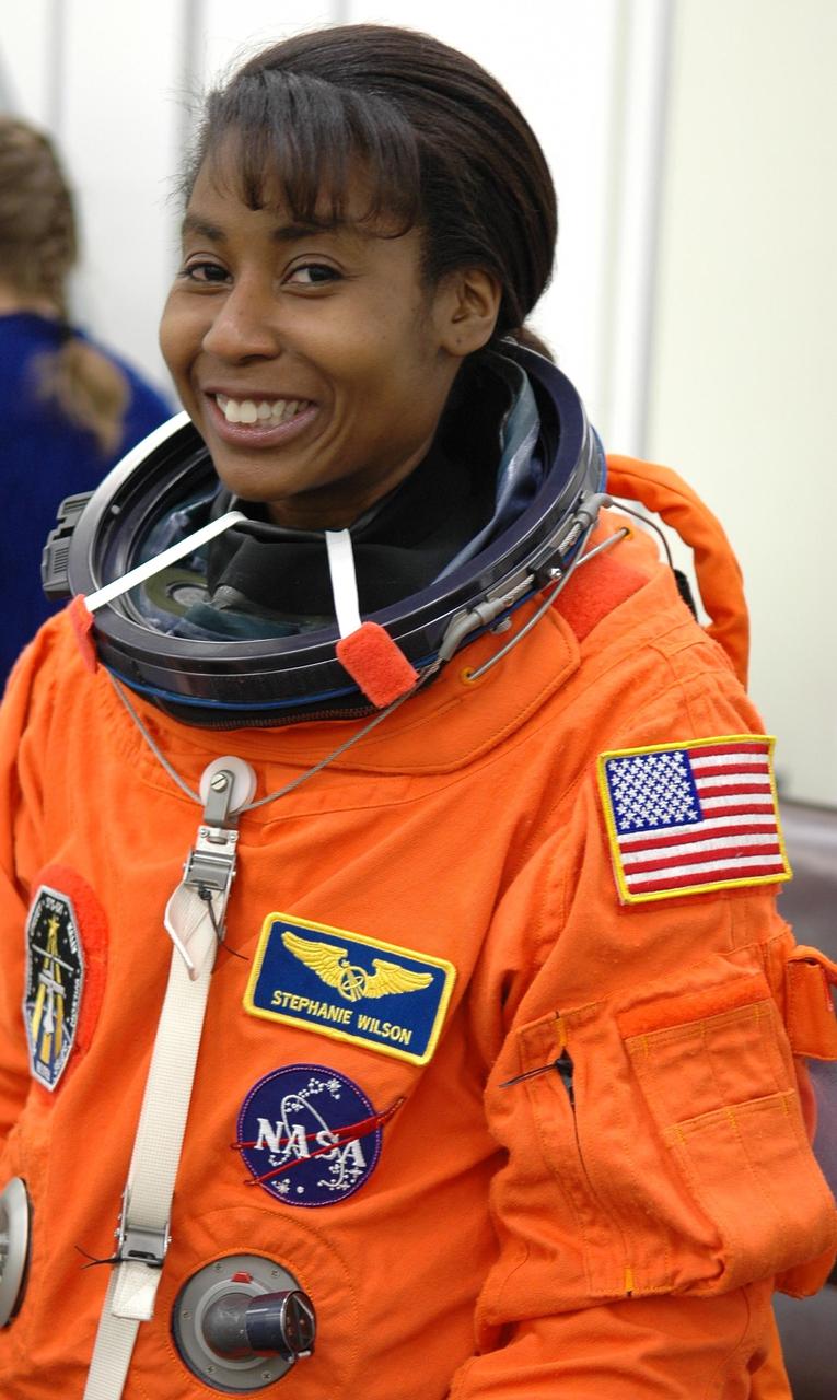 KENNEDY SPACE CENTER, FLA. -    The STS-121 crew are donning their orange launch and entry suits for launch today on Space Shuttle Discovery.  Mission Specialist Stephanie Wilson is excited about making her first space flight.  The launch is the 115th shuttle flight and the 18th U.S. flight to the International Space Station.  During the 12-day mission, the STS-121 crew will test new equipment and procedures to improve shuttle safety, as well as deliver supplies and make repairs to the International Space Station.  Photo credit: NASA/Kim Shiflett