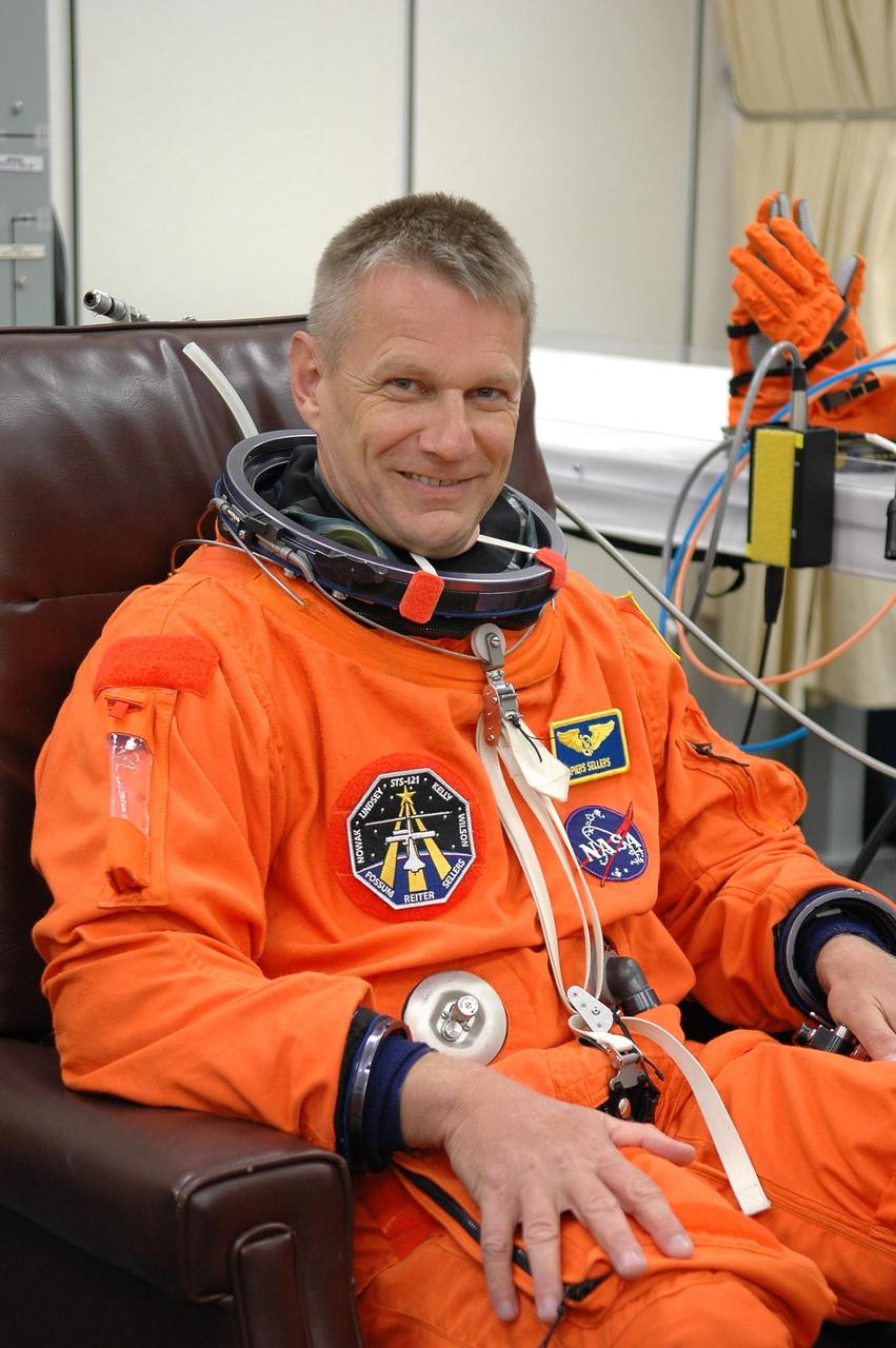 KENNEDY SPACE CENTER, FLA. -  STS-121 Mission Specialist Piers Sellers is eager for launch as he suits up before heading to Launch Pad 39B and liftoff.  The launch is the 115th shuttle flight and the 18th U.S. flight to the International Space Station.  During the 12-day mission, the STS-121 crew will test new equipment and procedures to improve shuttle safety, as well as deliver supplies and make repairs to the International Space Station.  Photo credit: NASA/Kim Shiflett