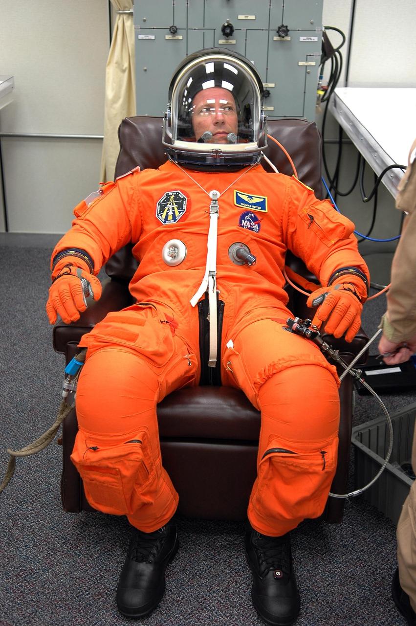 KENNEDY SPACE CENTER, FLA. -   The STS-121 crew are donning their orange launch and entry suits for launch today on Space Shuttle Discovery.  Here, Mission Specialist Thomas Reiter, who represents the European Space Agency, is ready to go.  Reiter is making his first space shuttle flight.  The launch is the 115th shuttle flight and the 18th U.S. flight to the International Space Station.  During the 12-day mission, the STS-121 crew will test new equipment and procedures to improve shuttle safety, as well as deliver supplies and make repairs to the International Space Station.  Photo credit: NASA/Kim Shiflett