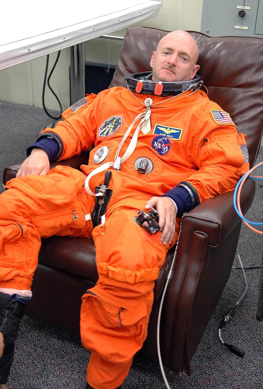 KENNEDY SPACE CENTER, FLA. -   Looking relaxed, STS-121 Pilot Mark Kelly is donning his launch and entry suit for launch today on Space Shuttle Discovery.  Kelly is making his second space flight.  The launch is the 115th shuttle flight and the 18th U.S. flight to the International Space Station.  During the 12-day mission, the STS-121 crew will test new equipment and procedures to improve shuttle safety, as well as deliver supplies and make repairs to the International Space Station.  Photo credit: NASA/Kim Shiflett