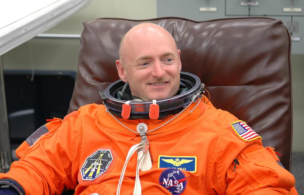 KENNEDY SPACE CENTER, FLA. - Smiling at the prospect of launch, STS-121 Pilot Mark Kelly is donning his launch and entry suit before the walkout and ride to Launch Pad 39B. Kelly is making his second space flight. The launch is the 115th shuttle flight and the 18th U.S. flight to the International Space Station. During the 12-day mission, the STS-121 crew will test new equipment and procedures to improve shuttle safety, as well as deliver supplies and make repairs to the International Space Station. Photo credit: NASA/Kim Shiflett