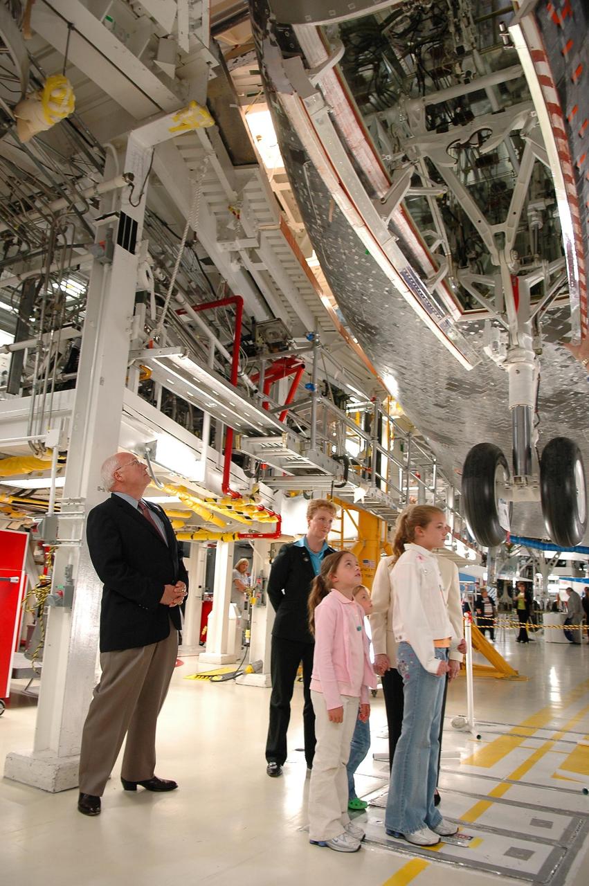 KENNEDY SPACE CENTER, FLA. - In the Orbiter Processing Facility, U.S. Vice President Dick Cheney takes a close look at the orbiter Atlantis while on a personal tour guided by Scott Thurston, Crew Exploration Vehicle manager in the Shuttle Processing Directorate.  Thurston previously was the NASA flow director for Atlantis.  Standing next to Cheney is Shana Dale, NASA deputy administrator.  Cheney flew in to view the launch of Space Shuttle Discovery on mission STS-121.