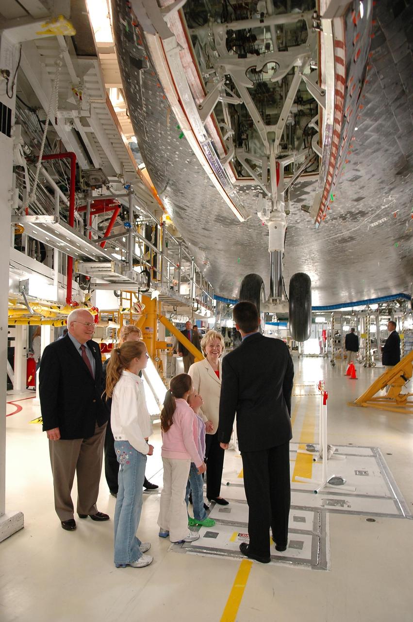 KENNEDY SPACE CENTER, FLA. -  In the Orbiter Processing Facility, Scott Thurston (right), Crew Exploration Vehicle manager in the Shuttle Processing Directorate, gives a personal tour to U.S. Vice President Dick Cheney (far left) and his family.  They are standing underneath the orbiter Atlantis. Thurston previously was the NASA flow director for Atlantis. Cheney flew in to view the launch of Space Shuttle Discovery on mission STS-121.  Photo credit: NASA/Kim Shiflett