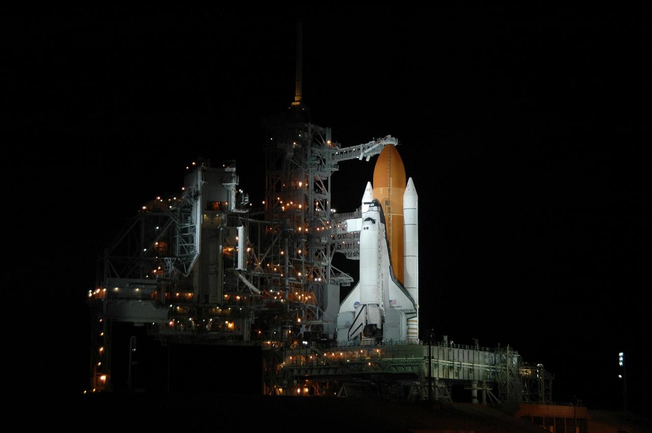KENNEDY SPACE CENTER, FLA. -     On Launch Pad 39B, Space Shuttle Discovery is bathed in spotlights under dark skies after the scrub of the launch attempt on mission STS-121.  The White Room is still extended toward the cockpit area where the STS-121 crew patiently waited for the launch just hours earlier.  The launch was scrubbed due to weather concerns and postponed 24 hours.   Photo credit: NASA/Ken Thornsley