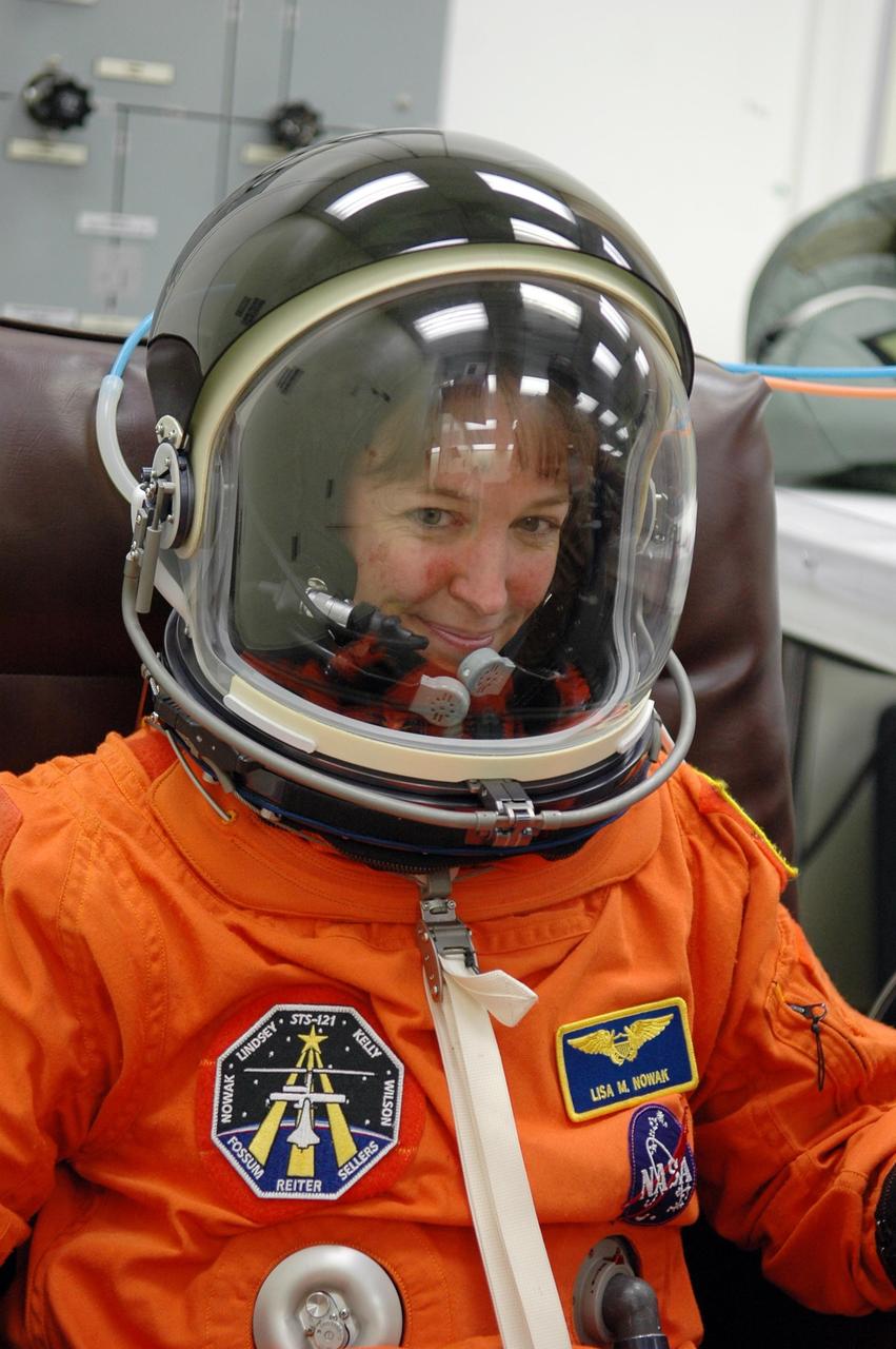 KENNEDY SPACE CENTER, FLA. -   STS-121 Mission Specialist Lisa Nowak is still eager for launch after suitup for a second launch attempt on Space Shuttle Discovery.  The first launch attempt July 1 was scrubbed due to weather concerns and postponed 24 hours.  The launch is the 115th shuttle flight and the 18th U.S. flight to the International Space Station.  During the 12-day mission, the STS-121 crew will test new equipment and procedures to improve shuttle safety, as well as deliver supplies and make repairs to the International Space Station. Photo credit: NASA/Kim Shiflett
