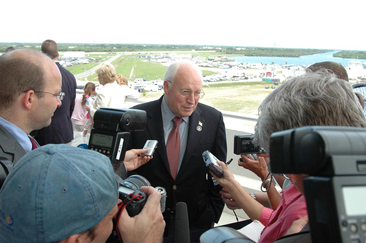 KENNEDY SPACE CENTER, FLA. - U.S. Vice President Dick Cheney talks to the media on the observation deck of the Operations and Support Building II at NASA's Kennedy Space Center. In the background, the white jacket, is Cheney's wife, Lynne. Cheney is at the Center to view the launch of Space Shuttle Discovery on mission STS-121.Photo credit: NASA/Kim Shiflett