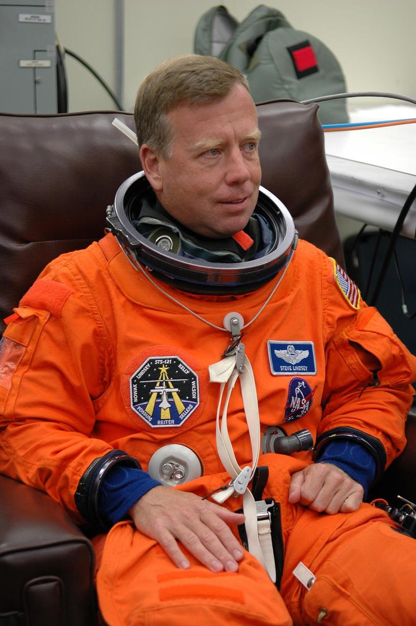 KENNEDY SPACE CENTER, FLA. - STS-121 Commander Steven Lindsey is eager for a third launch attempt on the mission. Here, he is donning his launch suit before heading to Launch Pad 39B. The July 2 launch attempt was scrubbed due to the presence of showers and thunderstorms within the surrounding area of the launch site. The launch of Space Shuttle Discovery on mission STS-121 is the 115th shuttle flight and the 18th U.S. flight to the International Space Station. During the 12-day mission, the STS-121 crew will test new equipment and procedures to improve shuttle safety, as well as deliver supplies and make repairs to the International Space Station. Photo credit: NASA/Kim Shiflett