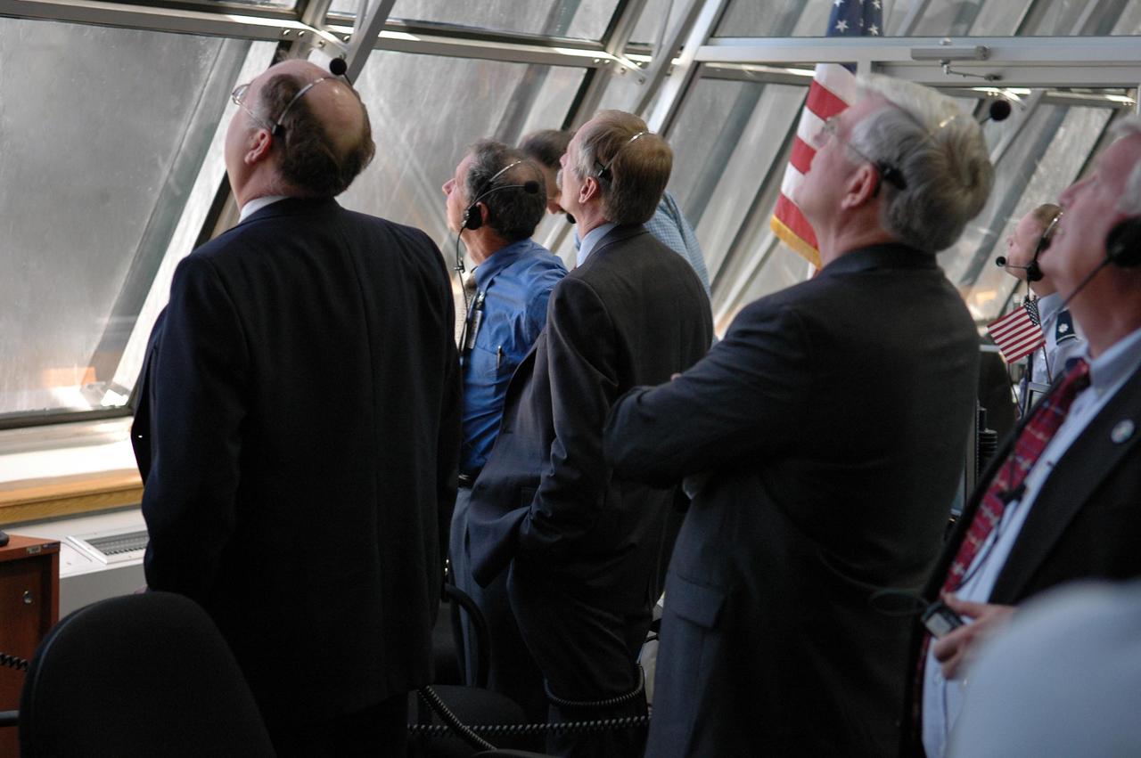 KENNEDY SPACE CENTER, FLA. -  In Firing Room 4 of the Launch Control Center, Shuttle Program manager Wayne Hale (far left), NASA Associate Administrator for Space Operations Mission Bill Gerstenmaier (third from left) and Center Director Jim Kennedy (far right) watch the historic ride of Space Shuttle Discovery as it rockets through the sky on mission STS-121 -- the first ever Independence Day launch of a space shuttle. Liftoff was on-time at 2:38 p.m. EDT.   During the 12-day mission, the STS-121 crew of seven will test new equipment and procedures to improve shuttle safety, as well as deliver supplies and make repairs to the International Space Station.  Landing is scheduled for July 16 or 17 at Kennedy's Shuttle Landing Facility.   Photo credit: NASA/Kim Shiflett