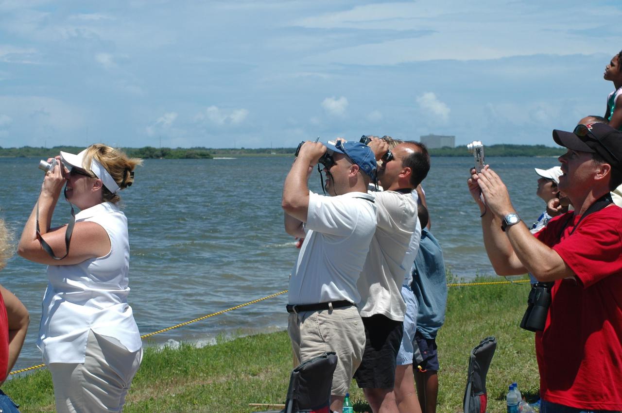 KENNEDY SPACE CENTER, FLA. - All eyes, and lenses, focus on the perfect launch of Space Shuttle Discovery on its third attempt in four days. Kicking off the Fourth of July with its own fireworks, the launch made history as it was the first ever launch on Independence Day. Liftoff was on-time at 2:38 p.m. EDT. During the 12-day mission, the STS-121 crew of seven will test new equipment and procedures to improve shuttle safety, as well as deliver supplies and make repairs to the International Space Station. Landing is scheduled for July 16 or 17 at Kennedy's Shuttle Landing Facility. Photo credit: NASA/Carl Winebarger