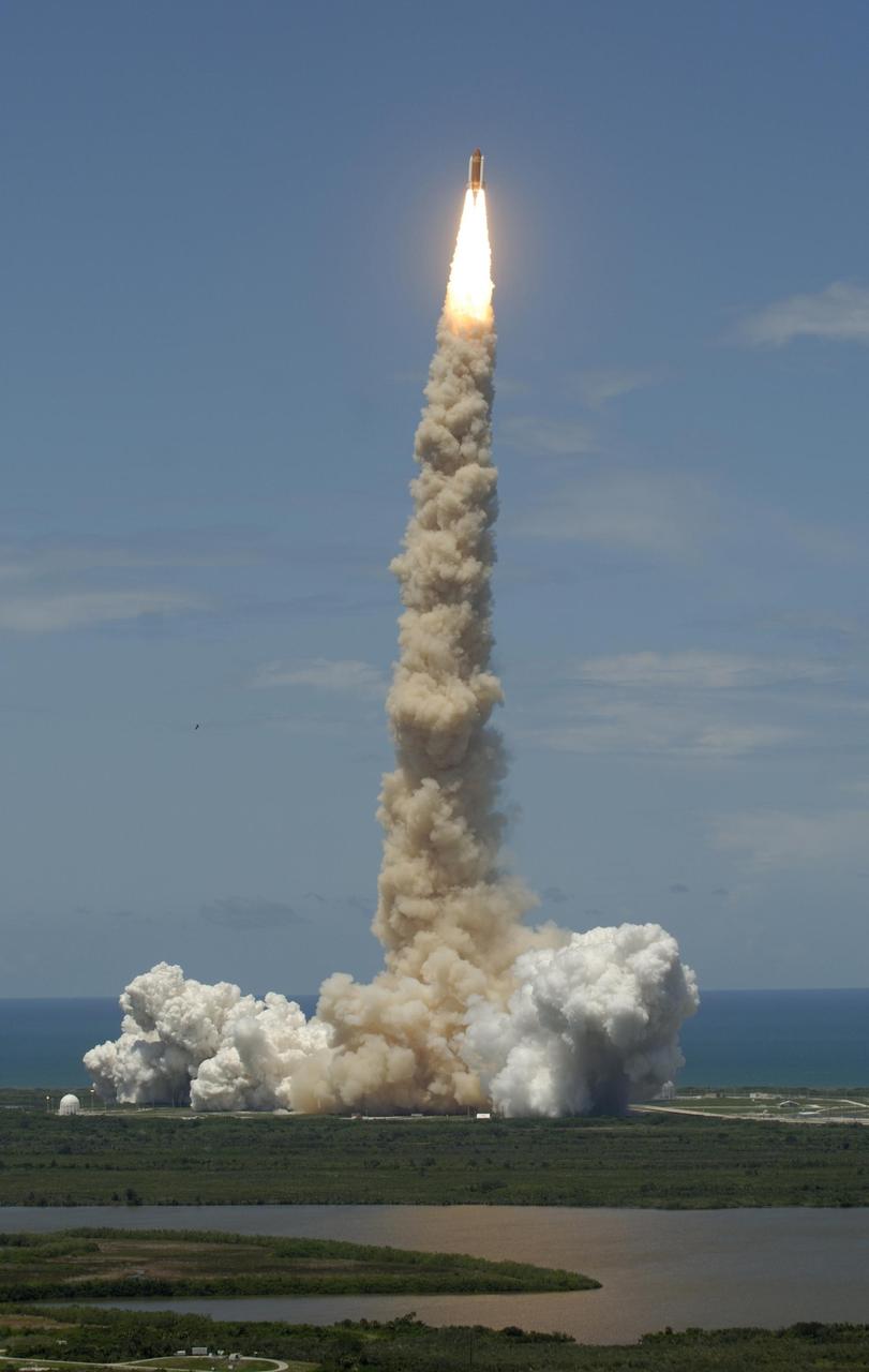 KENNEDY SPACE CENTER, FLA. - Space Shuttle Discovery shoots into Florida's blue sky over the blue Atlantic Ocean, kicking off Fourth of July fireworks with its own fiery display. History was made with the first ever launch on Independence Day. It was the third launch attempt in four days; the others were scrubbed due to weather concerns. Liftoff on mission STS-121 was on-time at 2:38 p.m. EDT. During the 12-day mission, the STS-121 crew of seven will test new equipment and procedures to improve shuttle safety, as well as deliver supplies and make repairs to the International Space Station. Landing is scheduled for July 16 or 17 at Kennedy's Shuttle Landing Facility. Photo courtesy of Nikon/Scott Andrews