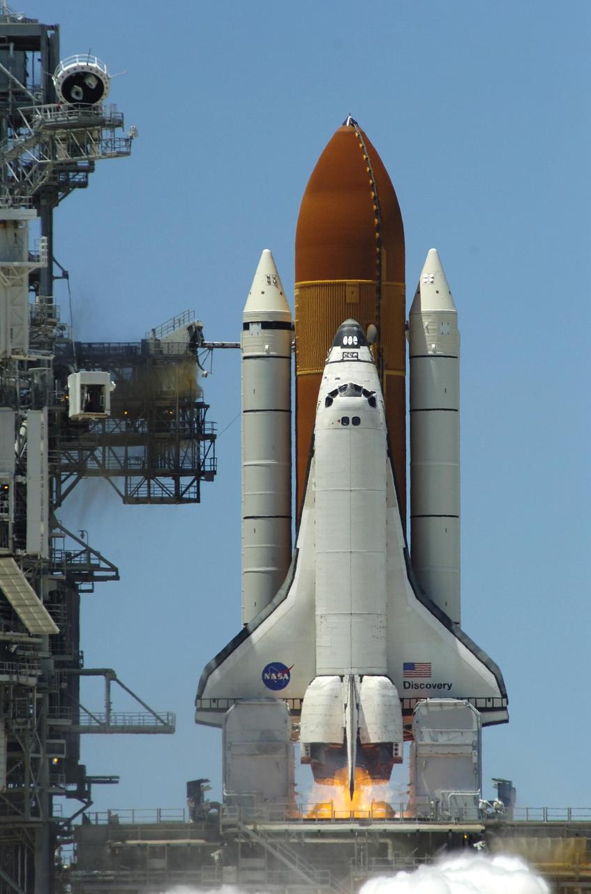 KENNEDY SPACE CENTER, FLA. -   The moment of ignition is captured in this photo of Space Shuttle Discovery being launched on mission STS-121 from Launch Pad 39B.   The launch was the first ever made on Independence Day.  Liftoff was on-time at 2:38 p.m. EDT.  During the 12-day mission, the STS-121 crew of seven will test new equipment and procedures to improve shuttle safety, as well as deliver supplies and make repairs to the International Space Station.  Landing is scheduled for July 17 at Kennedy's Shuttle Landing Facility. Photo courtesy of Nikon/Scott Andrews
