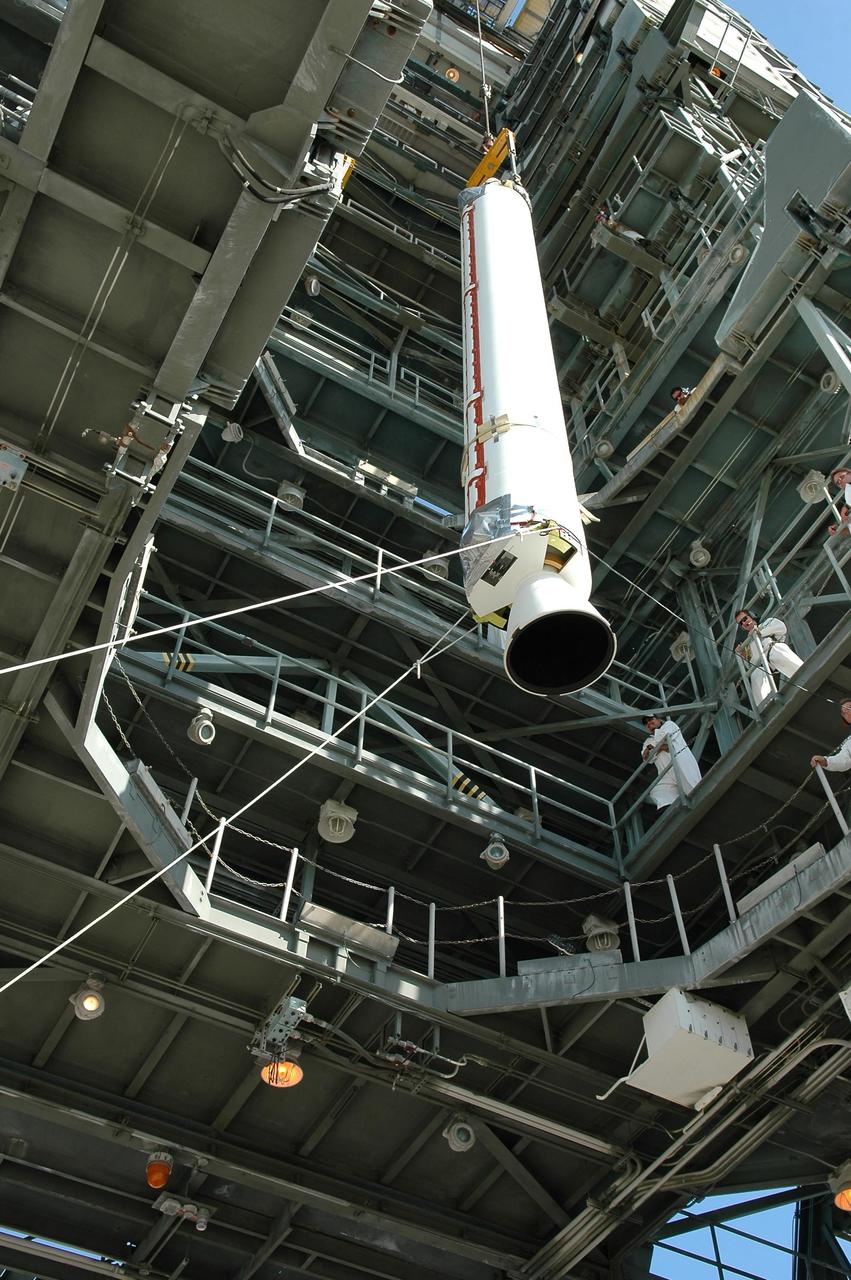KENNEDY SPACE CENTER, FLA. - Viewed from below, a solid rocket booster is lifted into the mobile service tower for mating with the Boeing Delta II rocket already in place. The Delta rocket is the launch vehicle for NASA's Solar Terrestrial Relations Observatory (STEREO). Preparations are under way for a liftoff no earlier than Aug. 1. STEREO consists of two spacecraft whose mission is the first to take measurements of the sun and solar wind in 3-D. This new view will improve our understanding of space weather and its impact on the Earth. Photo credit: NASA/Kim Shiflett