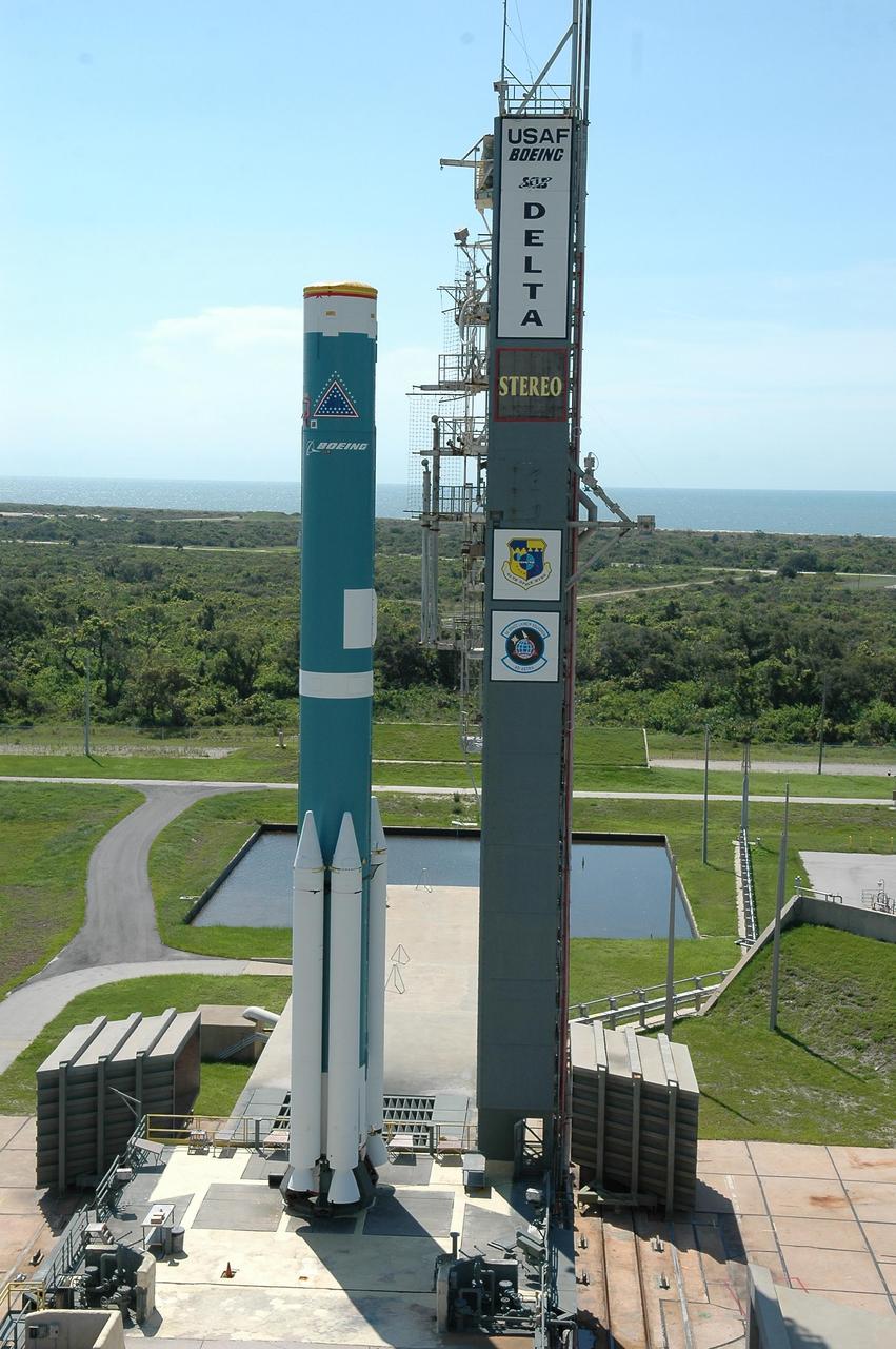 KENNEDY SPACE CENTER, FLA. - On Launch Pad 17-B at Cape Canaveral Air Force Station in Florida, the Boeing Delta II rocket waits next to the gantry for the remaining solid rocket boosters to be installed. The Delta rocket is the launch vehicle for NASA's Solar Terrestrial Relations Observatory (STEREO). Preparations are under way for a liftoff no earlier than Aug. 1. STEREO consists of two spacecraft whose mission is the first to take measurements of the sun and solar wind in 3-D. This new view will improve our understanding of space weather and its impact on the Earth. Photo credit: NASA/Kim Shiflett