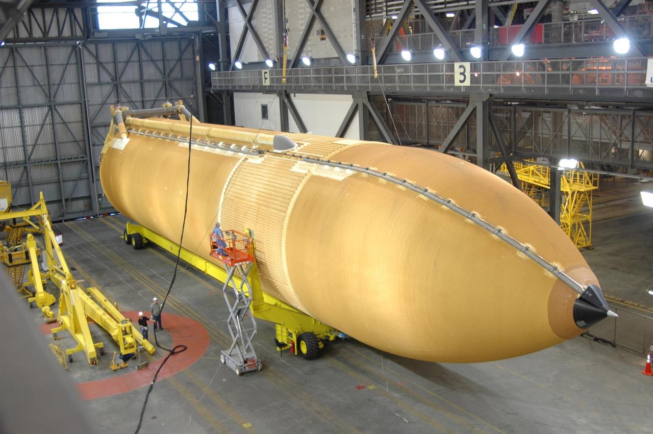 KENNEDY SPACE CENTER, FLA. -   Workers in the Vehicle Assembly Building attach a crane to external tank No. 118 in order to raise it vertical and lift it into high bay 3 for mating with solid rocket boosters stacked there.  The tank is designated to fly on mission STS-115 with Atlantis.  It will fly with many major safety changes, including the removal of the protuberance air load ramps. The mission will deliver the second port truss segment, the P3/P4 Truss, to attach to the first port truss segment, the P1 Truss, as well as deploy solar array set 2A and 4A.  Launch of Space Shuttle Atlantis is scheduled for late August. Photo credit: NASA/Jim Grossmann